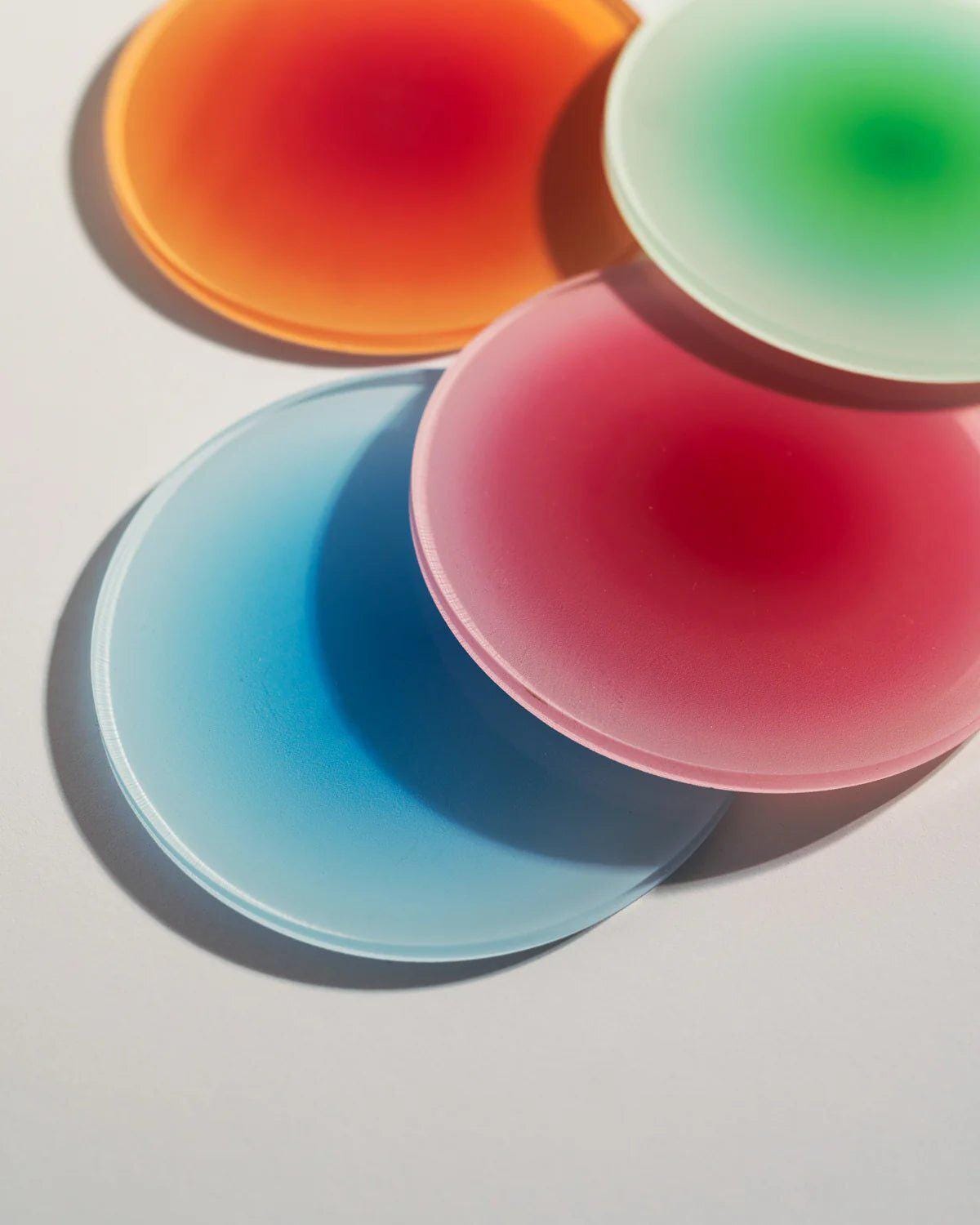 Gradient ombre table coasters in vibrant colors – glossy acrylic with sleek, contemporary appeal