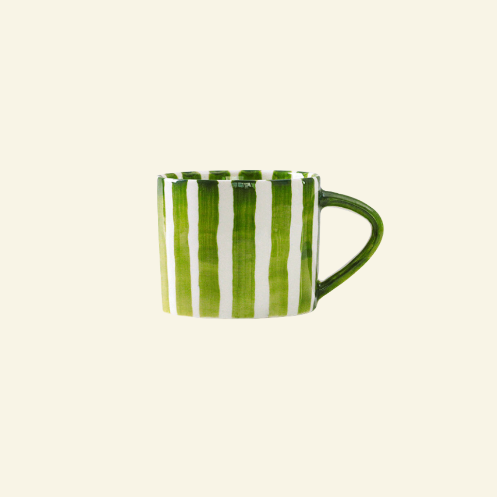Green and white Artisan Ceramic Mug on a beige background