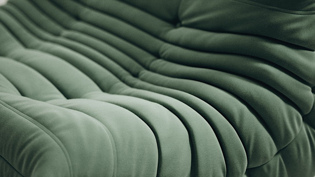 Green Togo-style sofa set with velvet suede upholstery and a low, frameless caterpillar design for modern living spaces.