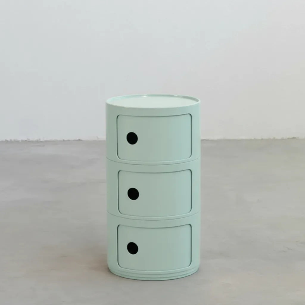 Kartell Componibili dupe round modular storage unit in light blue glossy plastic with three tiers on concrete floor in white studio