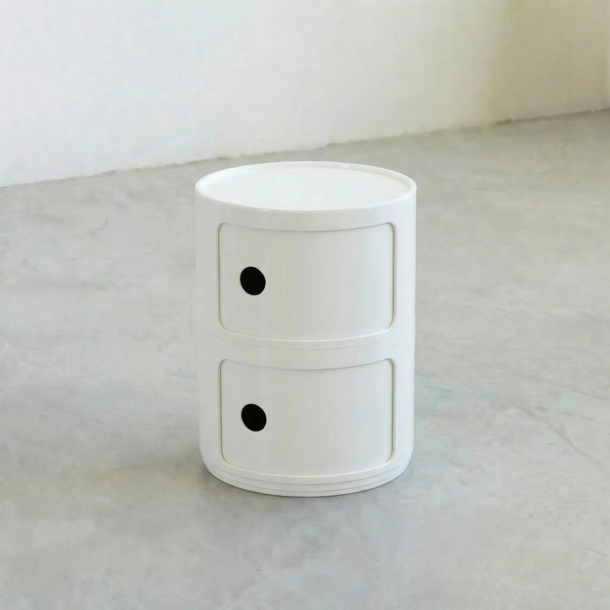 Kartell Componibili dupe round modular storage unit in white glossy plastic with two tiers on concrete floor in white studio