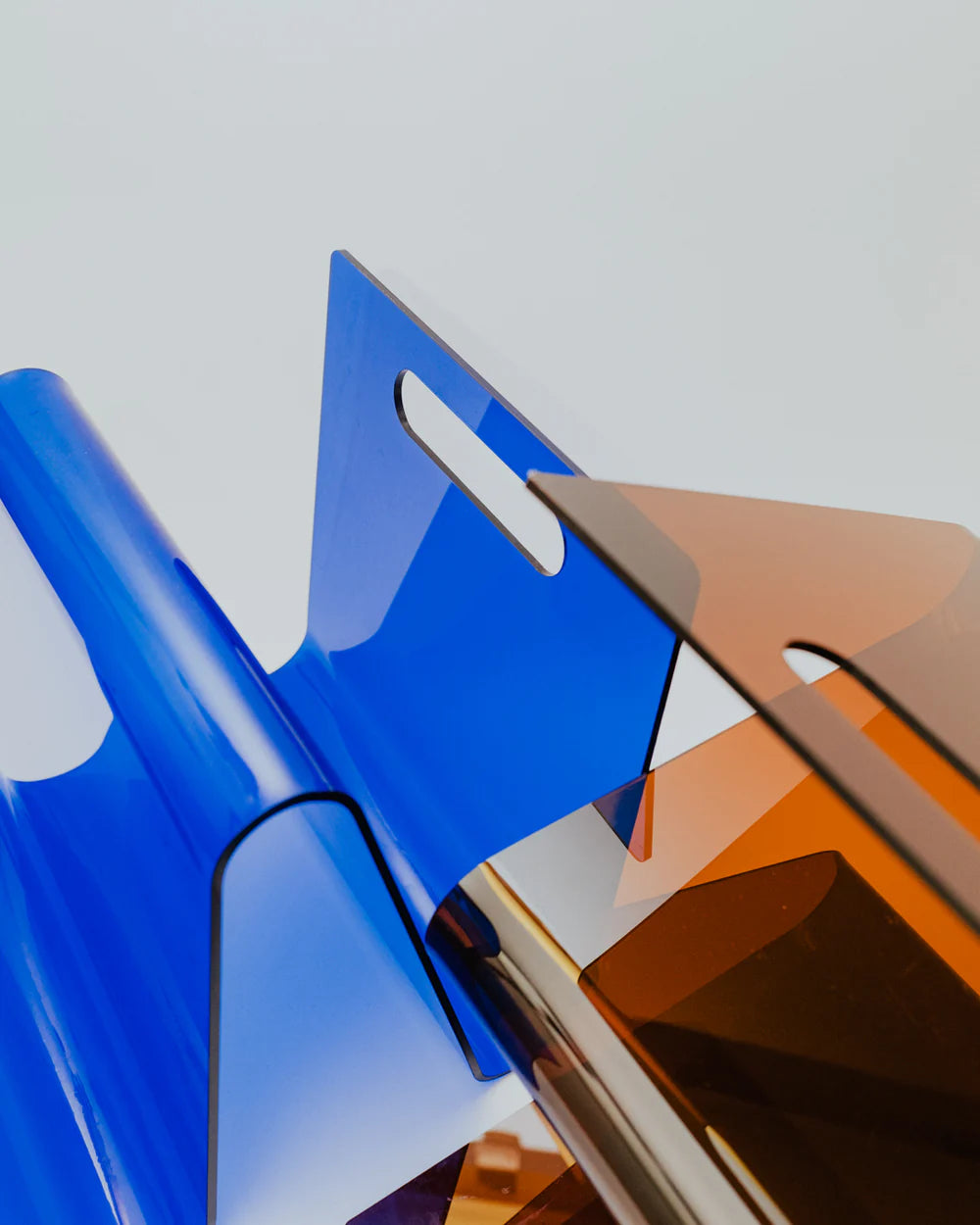 Close-up of a blue and amber magazine rack on a white background