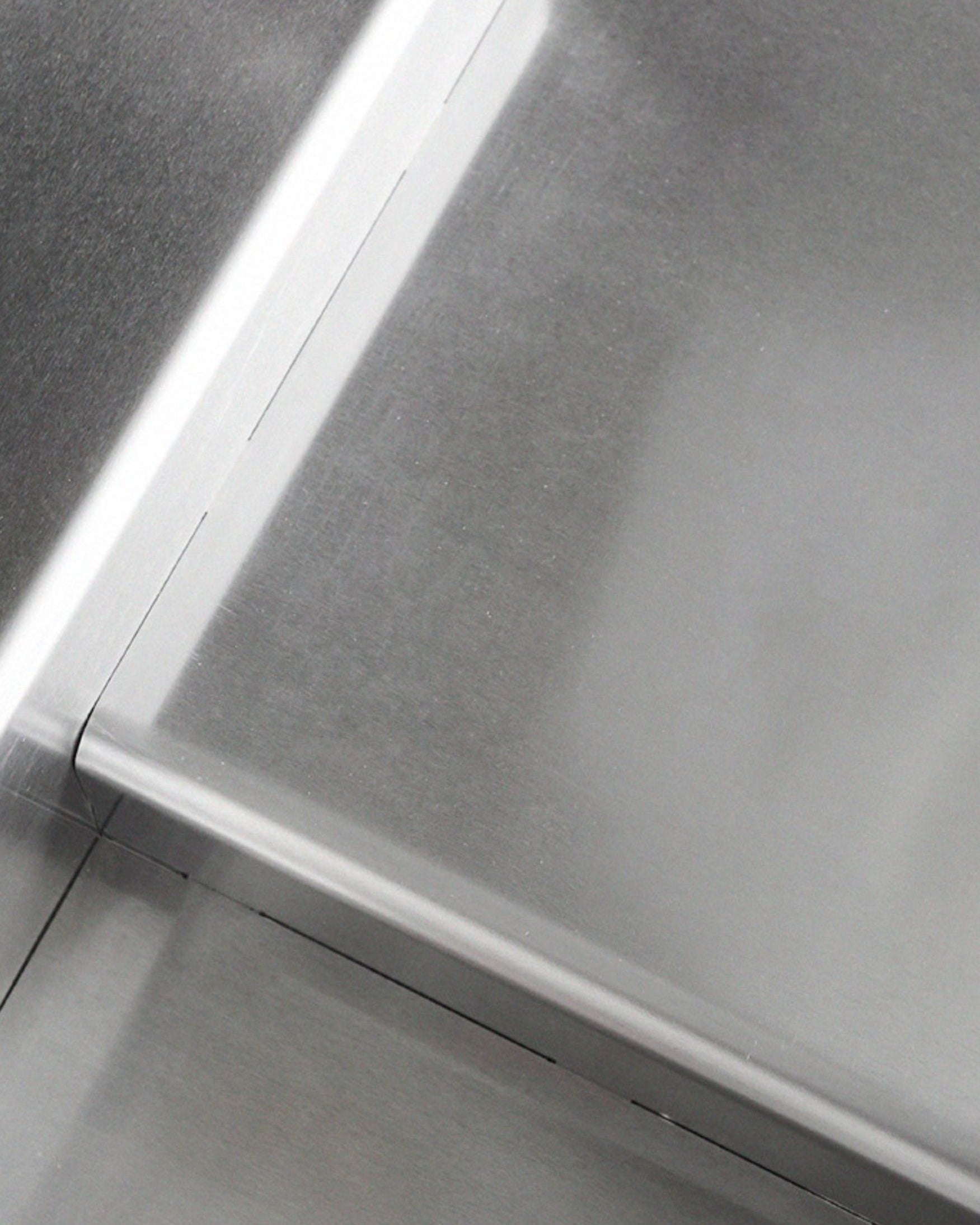 Close-up of chrome finish on stainless steel accent table – reflective surface adds modern glamour