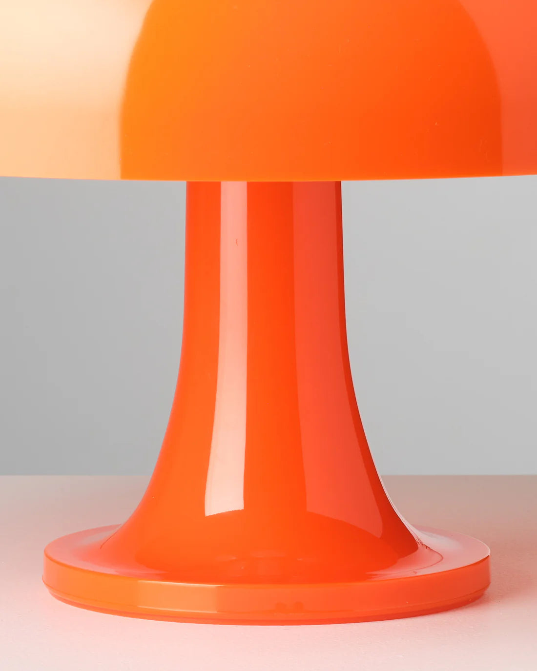 Orange Nesso Replica Table Lamp on a gradient background