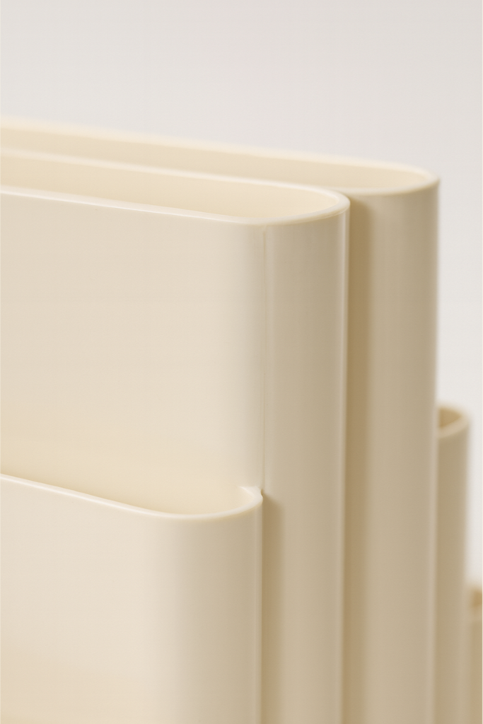 Close-up of beige cascade magazine rack on a light background