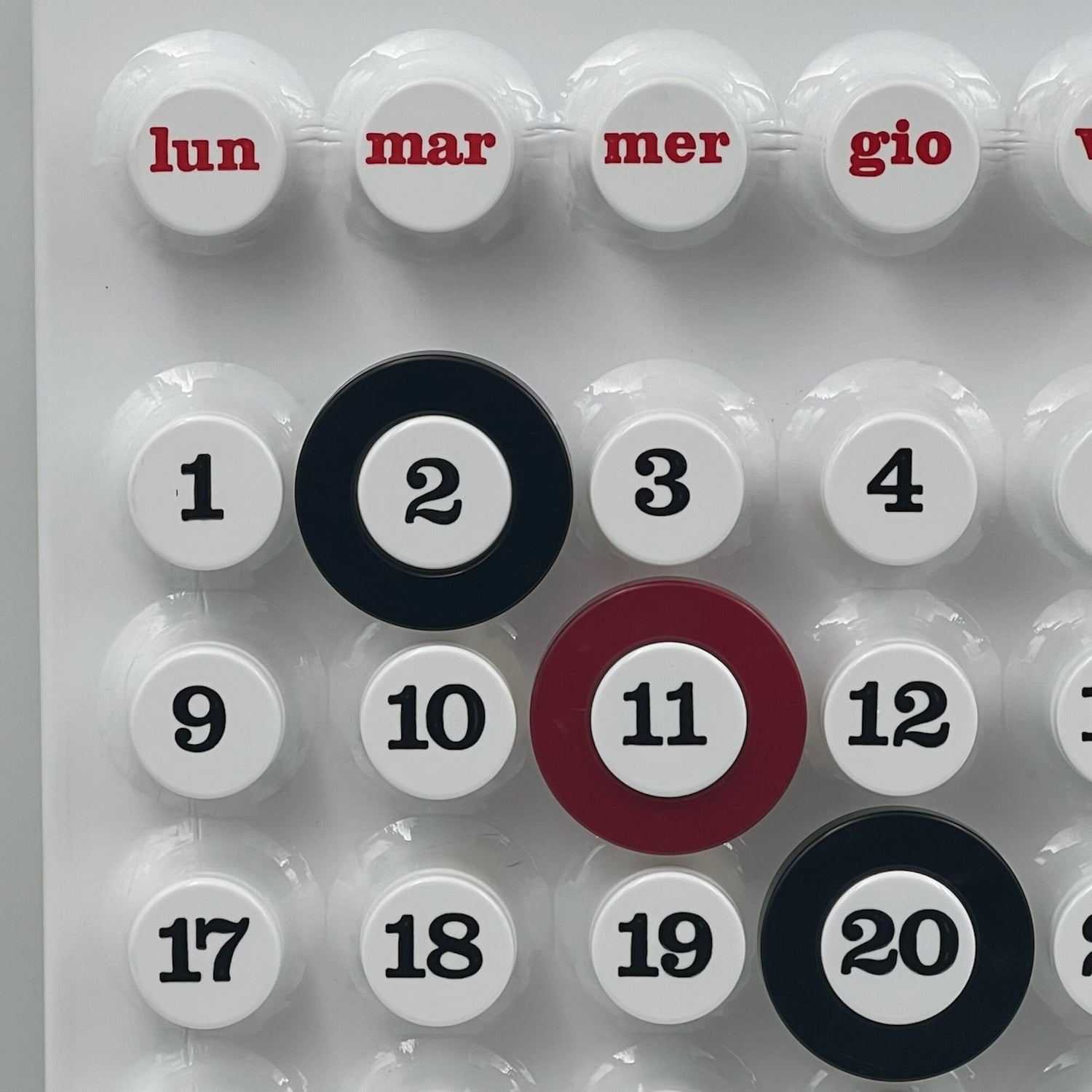 Close-up of the white Ring-a-Date Calendar showing the rotating date rings and smooth matte finish in modern Italian design