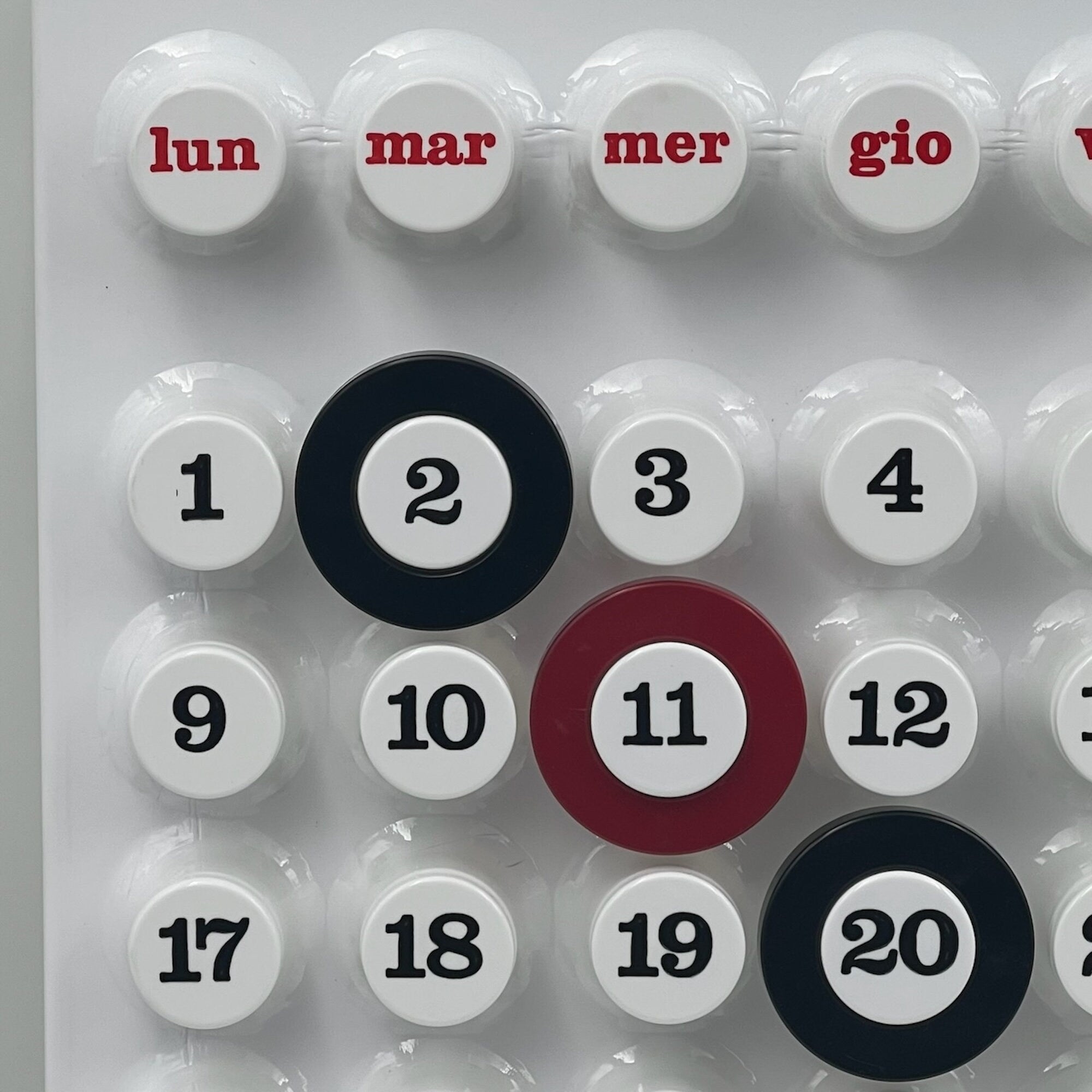 Close-up of the white Ring-a-Date Calendar showing the rotating date rings and smooth matte finish in modern Italian design
