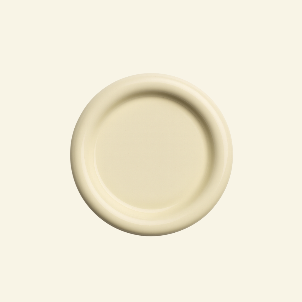 Round chunky thick ceramic plate on a beige background