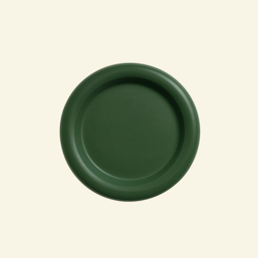 Round chunky thick ceramic plate on a beige background