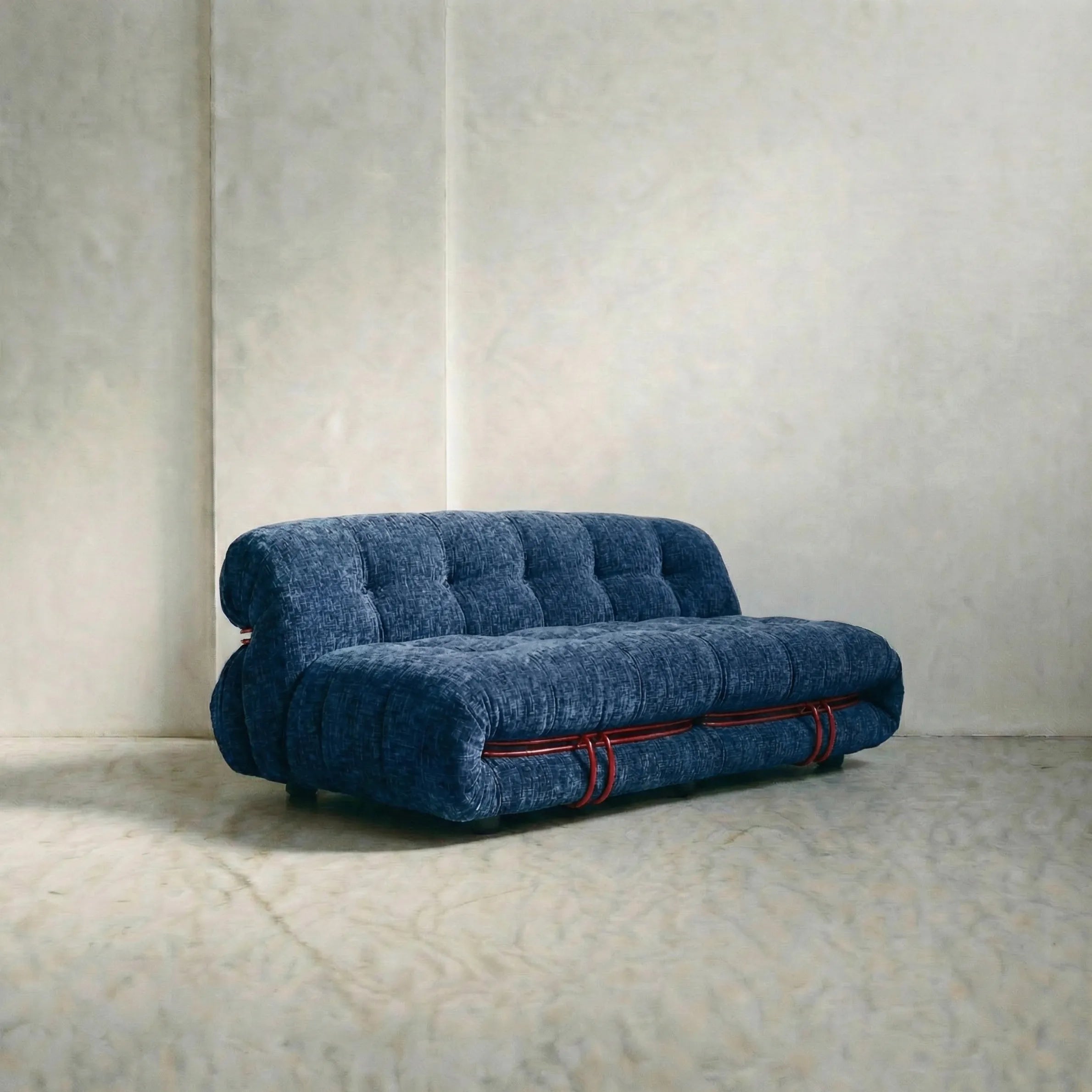 soriana sofa 2-seater dupe in blue chenille with red chrome bar on gray floor with white wall background