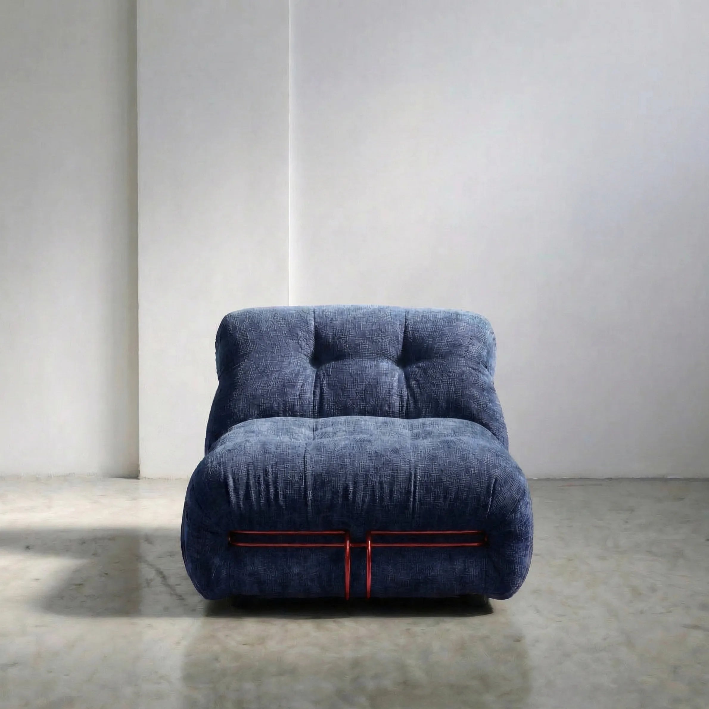 soriana chair dupe in blue chenille with red chrome bar angled view on gray floor with white wall background