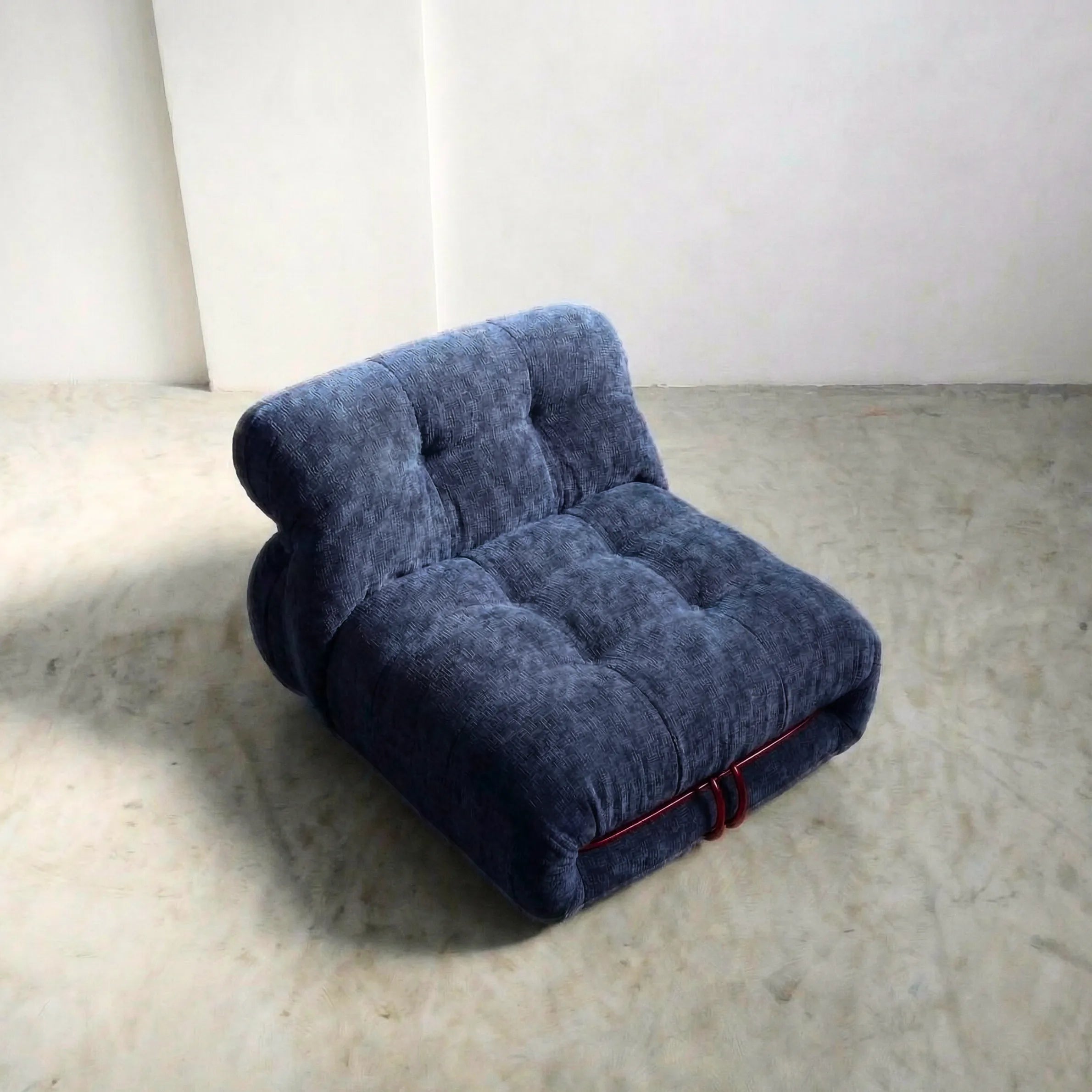 soriana chair dupe in blue chenille with red chrome bar close-up with chrome frame detail on light gray surface