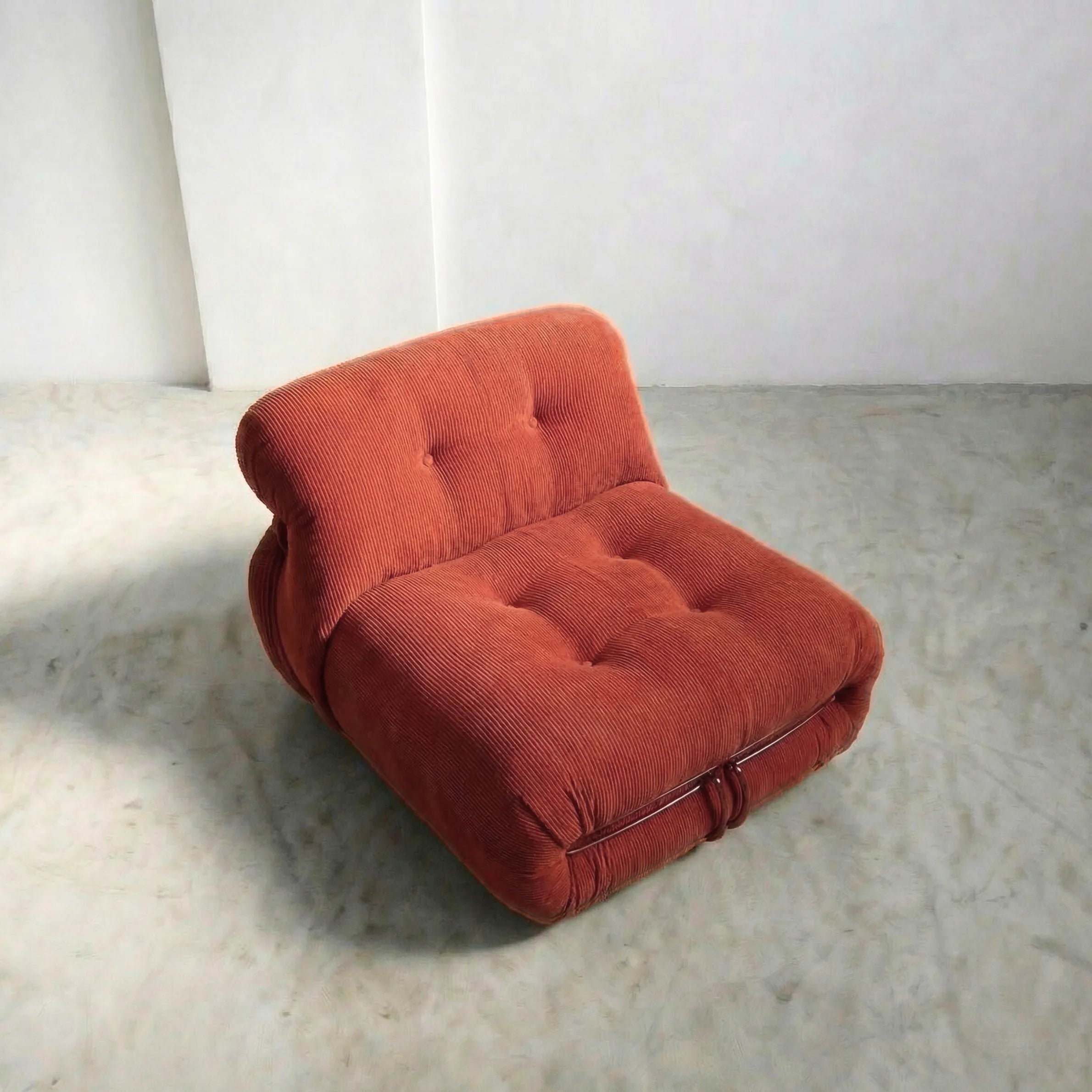 soriana chair dupe in terracotta corduroy close-up with chrome frame detail on light gray surface