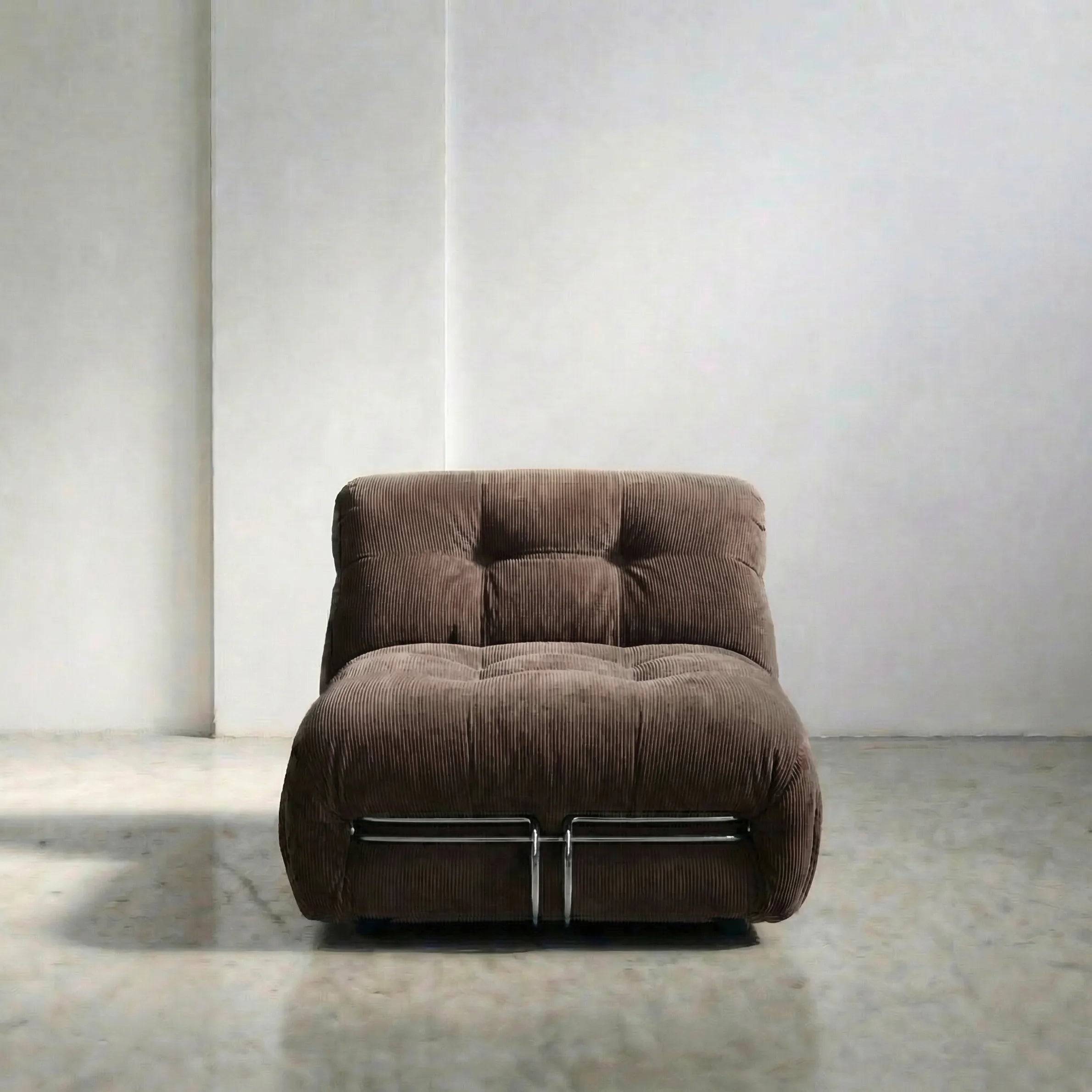 soriana chair dupe in chestnut corduroy angled view on gray floor with white wall background
