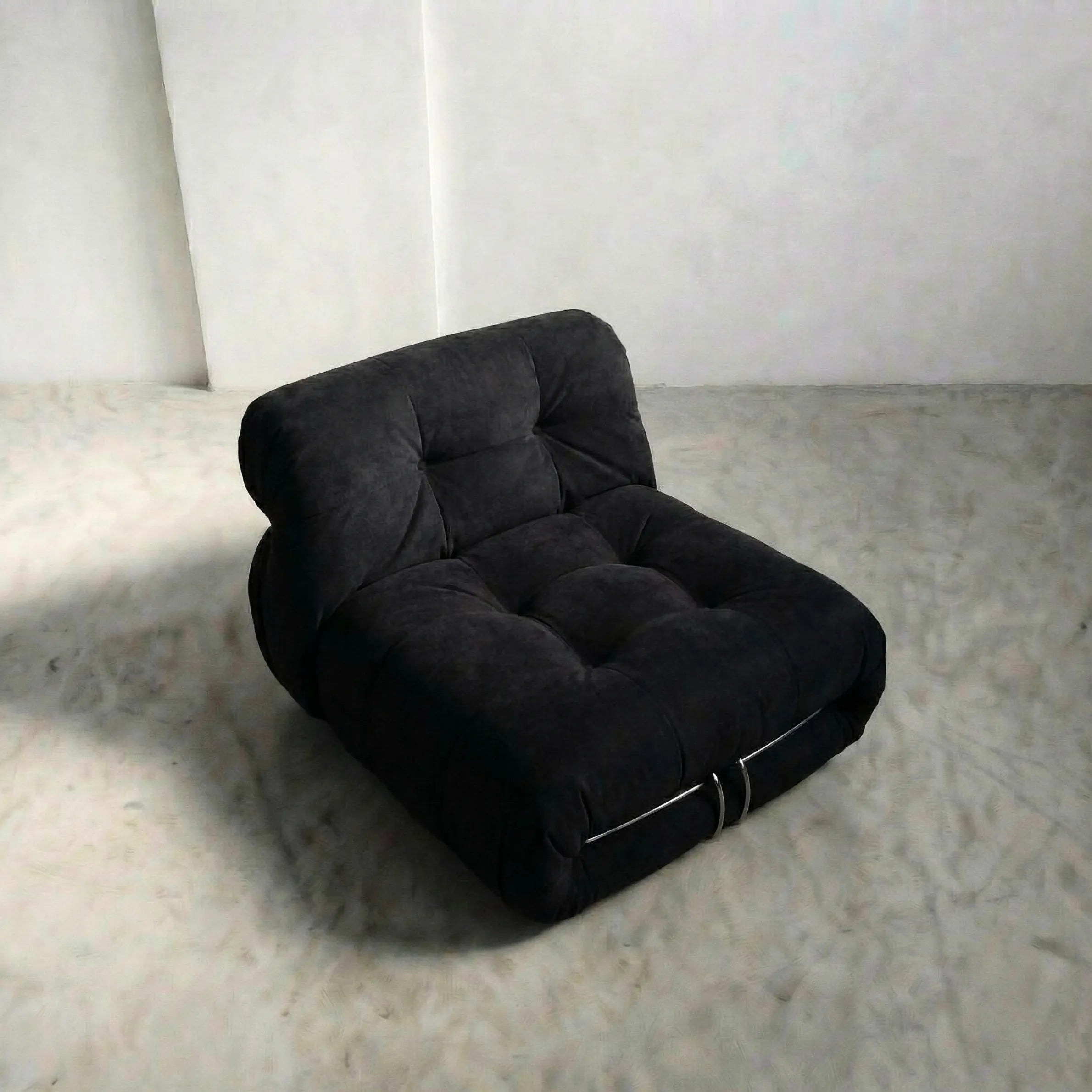 soriana chair dupe in black flannel on gray floor with white wall background