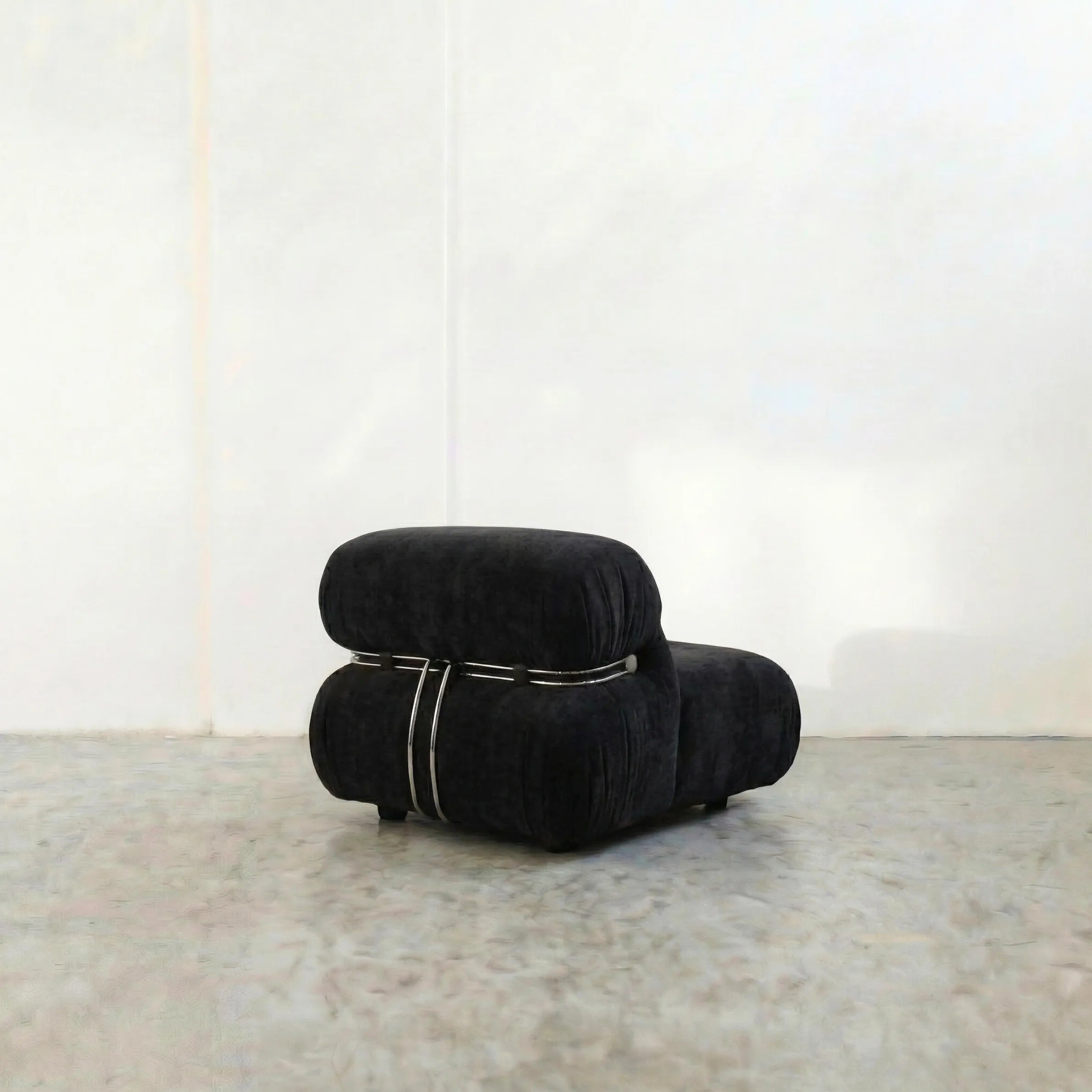 soriana chair dupe in black flannel close-up with chrome clamp detail on light background