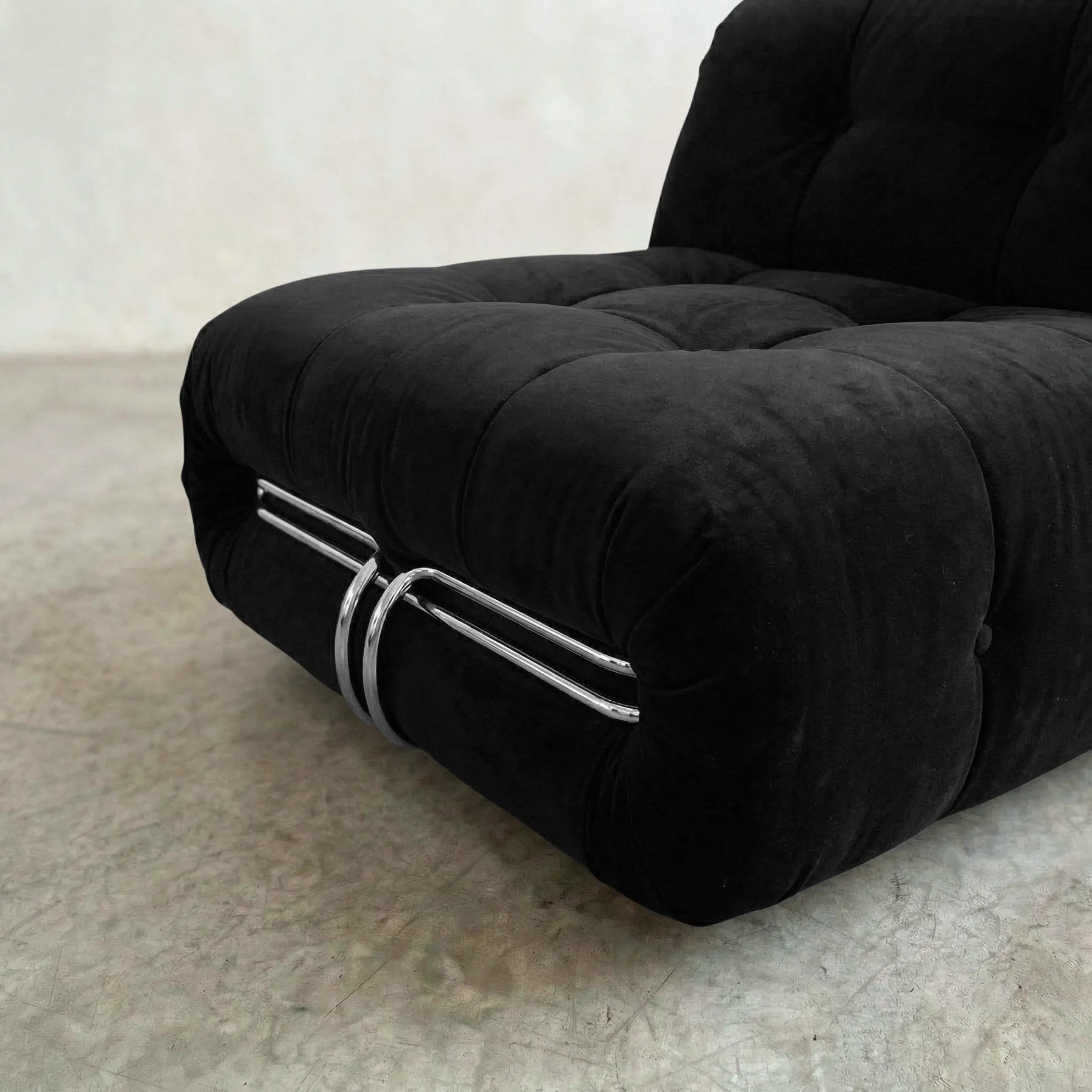 soriana chair dupe in black flannel angled view on gray floor with white wall background