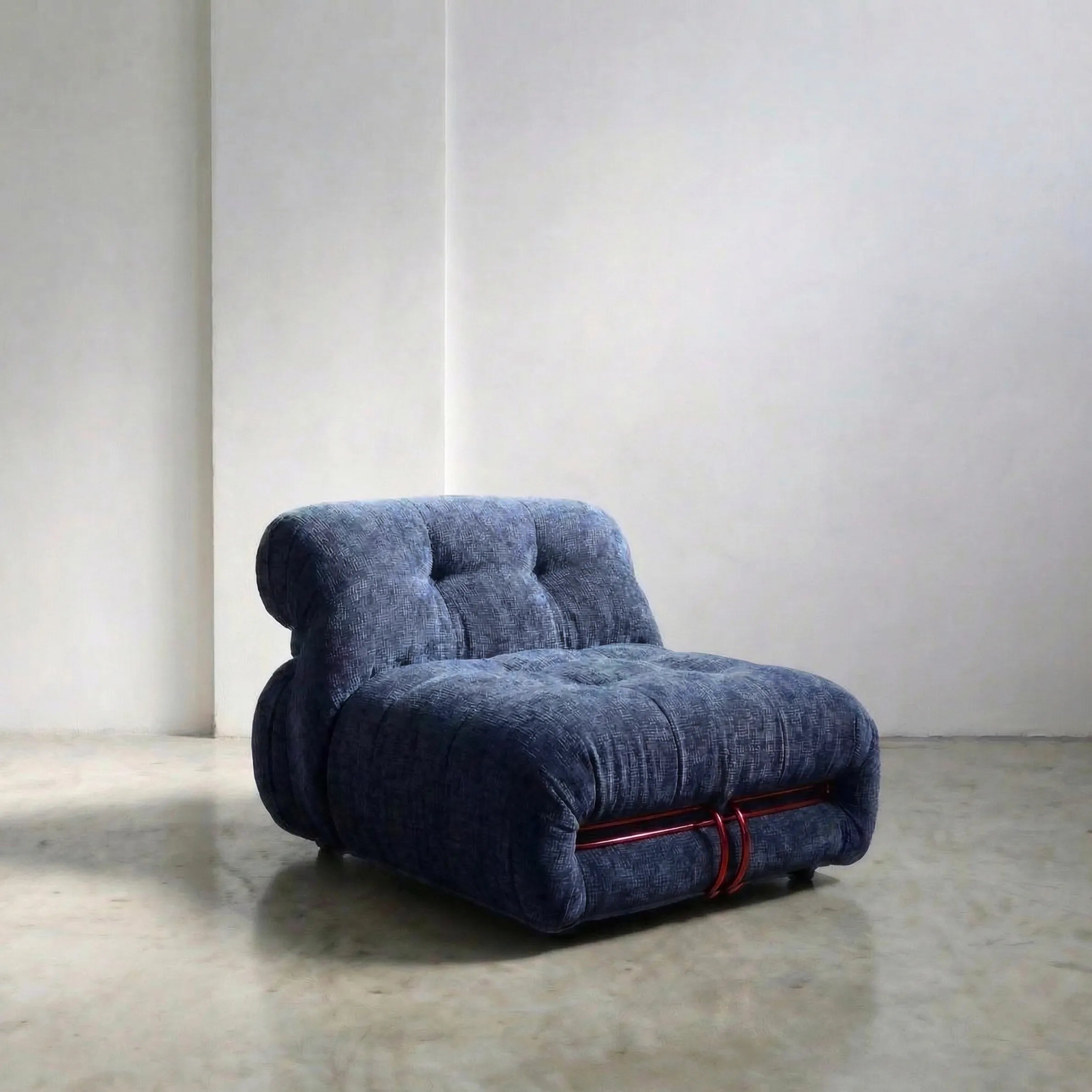 soriana chair dupe in blue chenille with red chrome bar on gray floor with white wall background