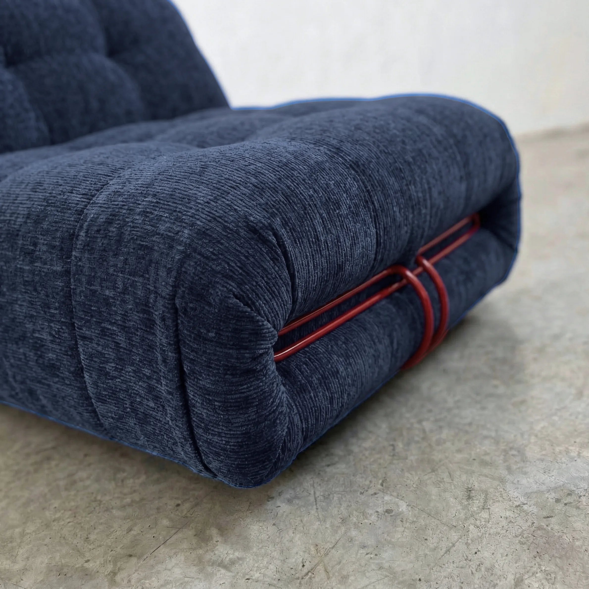 soriana chair dupe in blue chenille with red chrome bar close-up with chrome clamp detail on light background