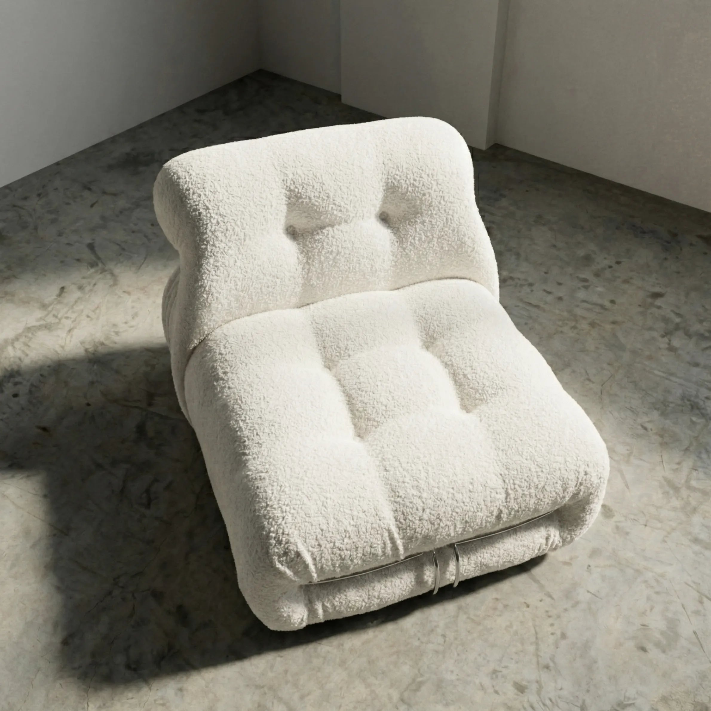 soriana chair dupe in white bouclé angled view on gray floor with white wall background