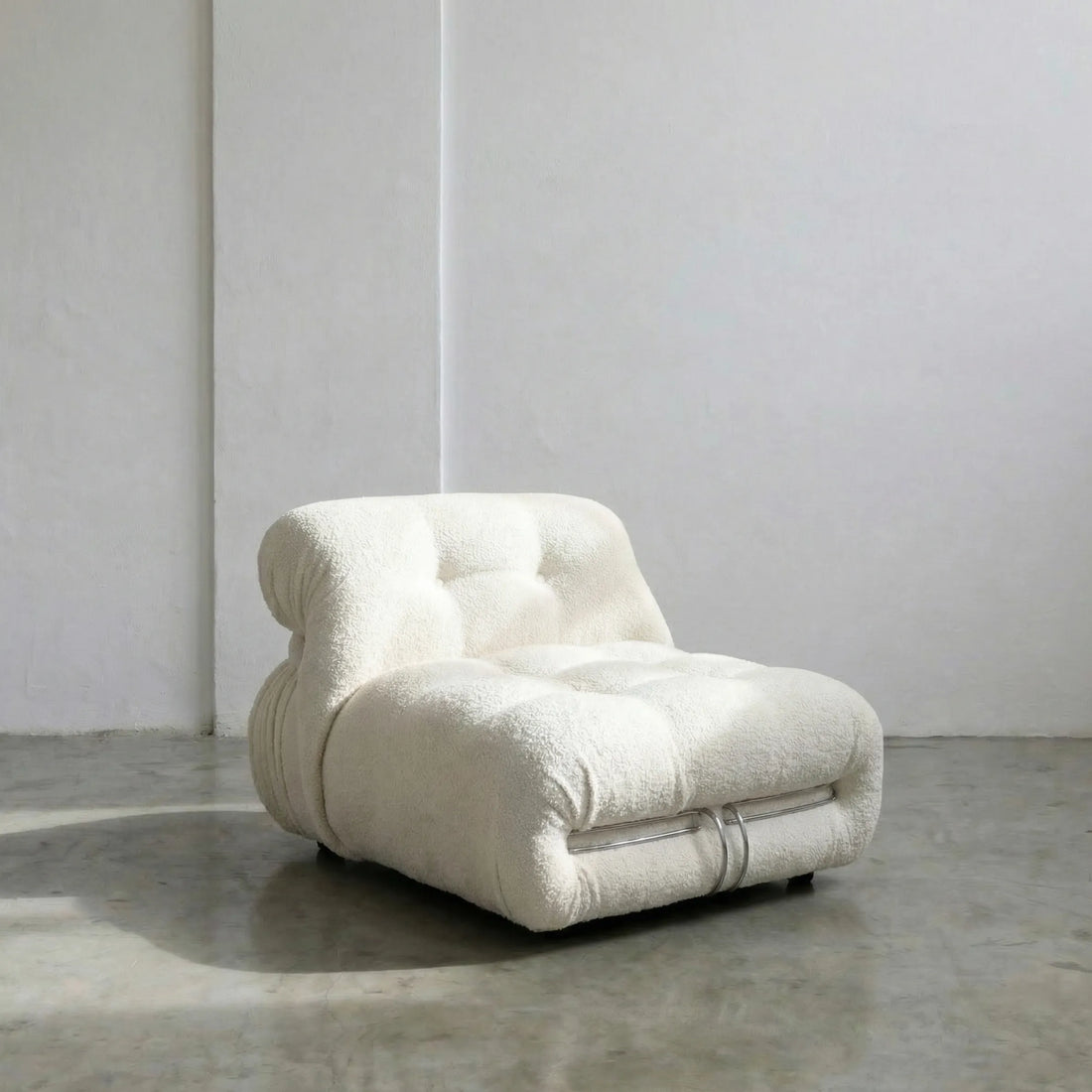 soriana chair dupe in white bouclé on gray floor with white wall background