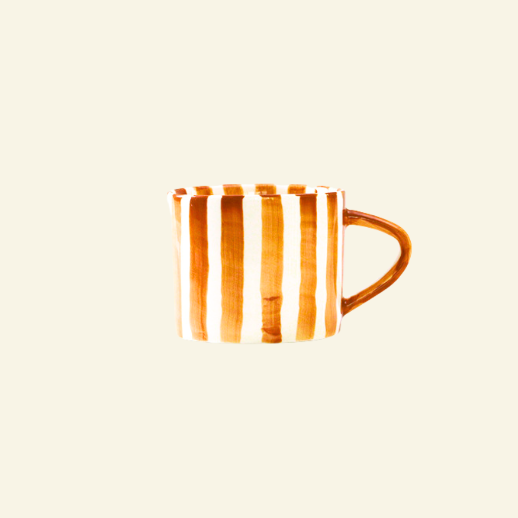 Orange and white striped Artisan Ceramic Mug on a beige background