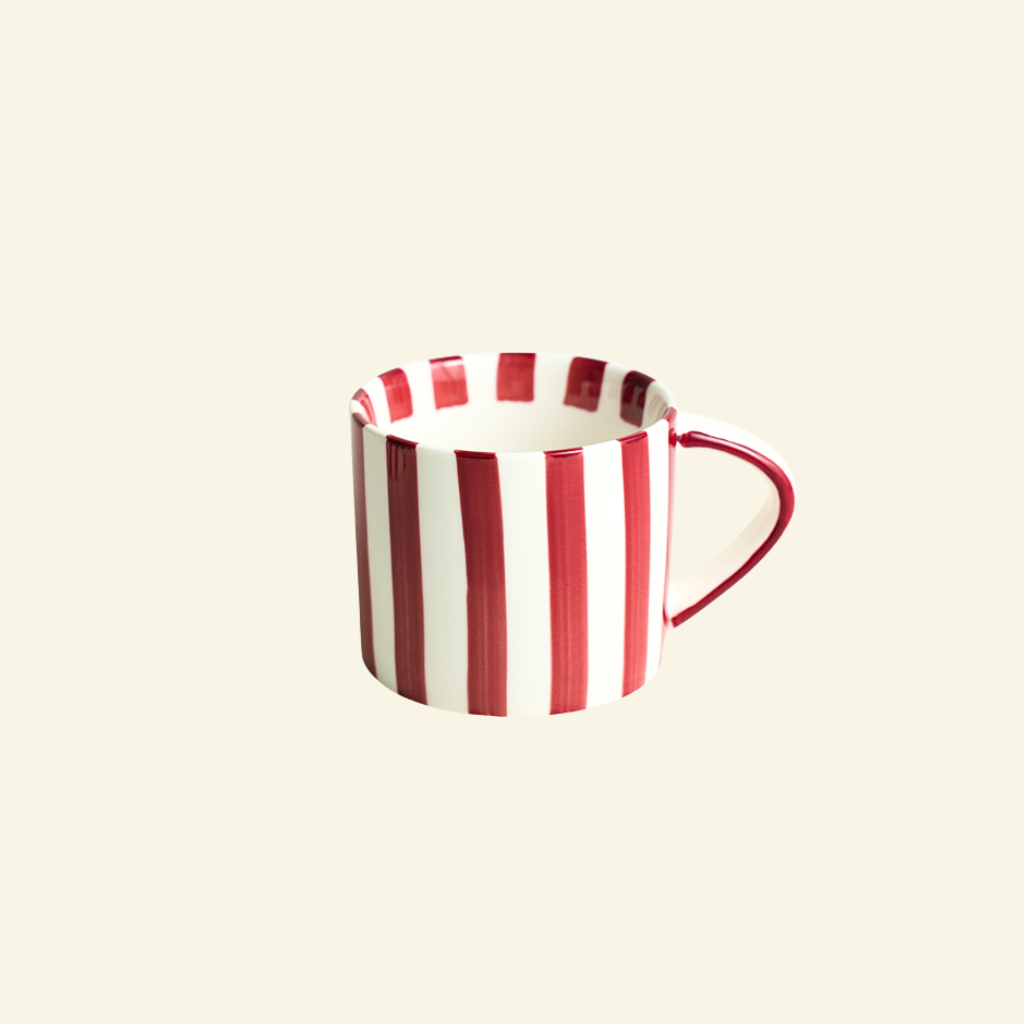 Red and white striped Artisan Ceramic Mug on a beige background