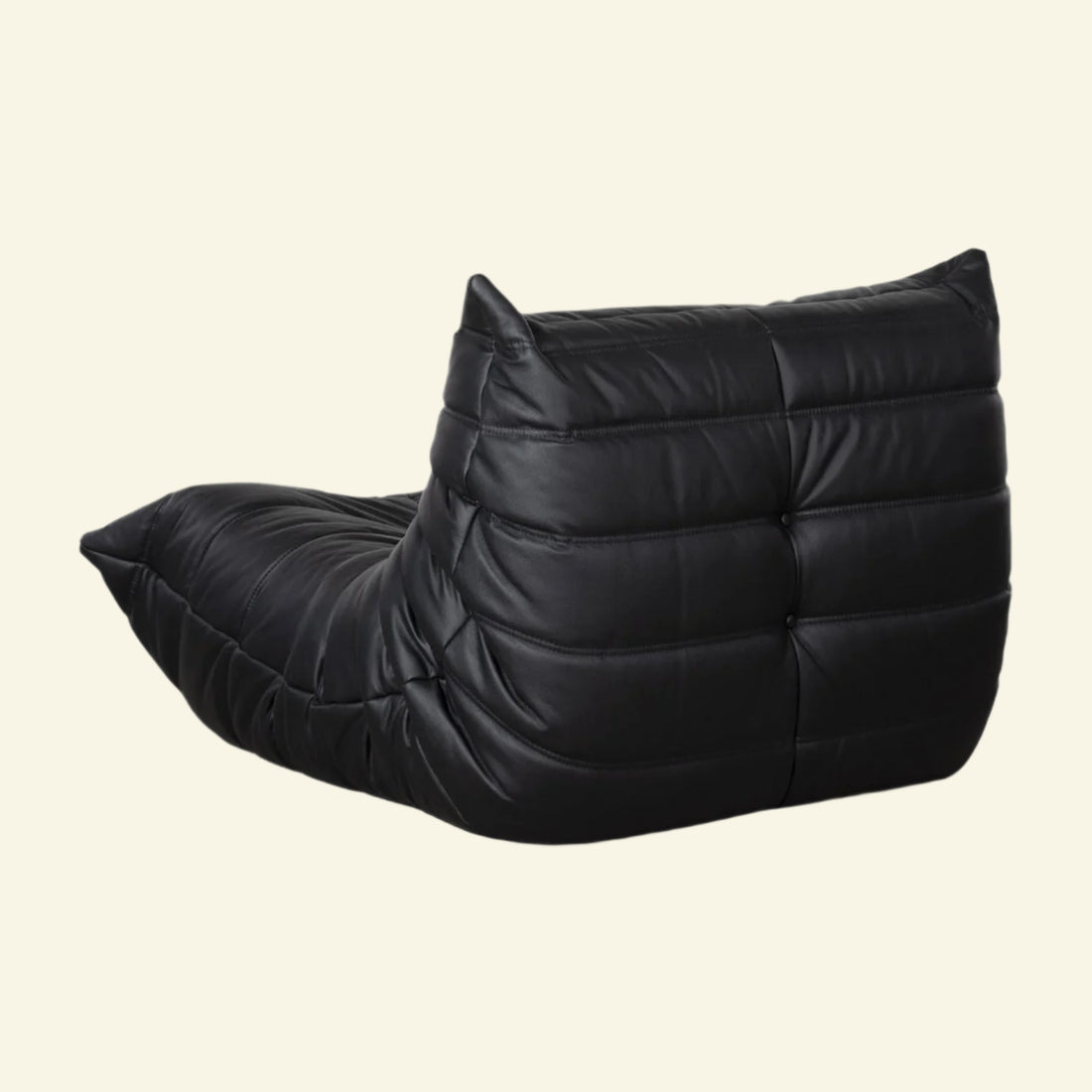 Black wedge-shaped togo leather dupe bean bag chair on a white background