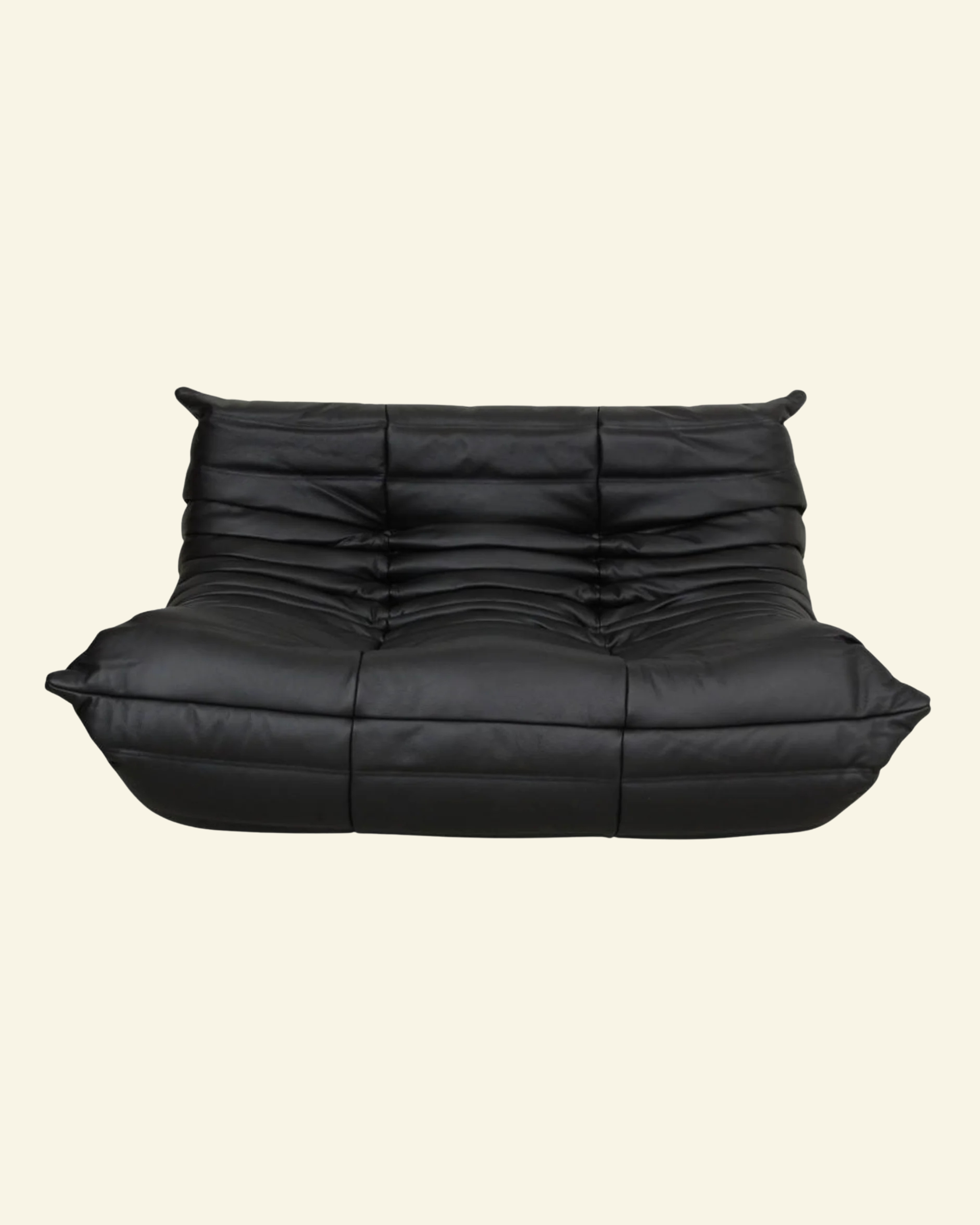 Togo black leather 2-seater dupe on a beige background