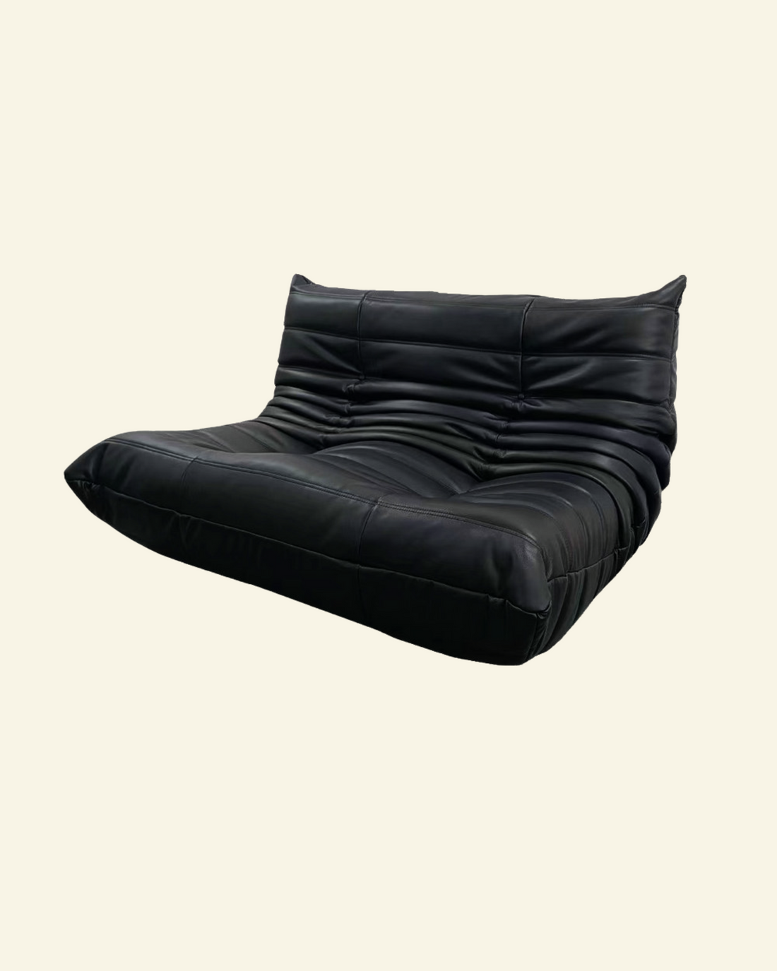 Black leather lounge loveseat replica on a beige background