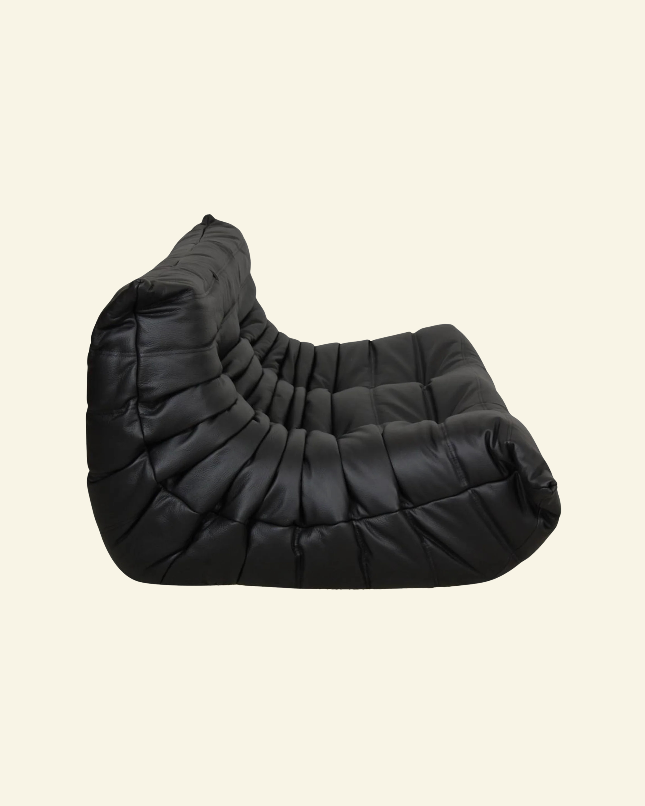 Togo black leather 2-seater dupe on beige background - loveseat