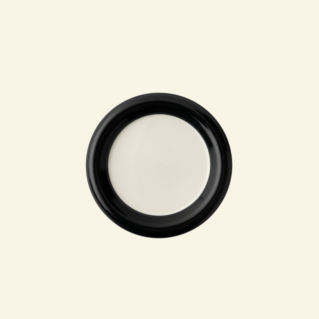 Two-Tone Chunky Ceramic Plate in black and white on a beige background on a beige background