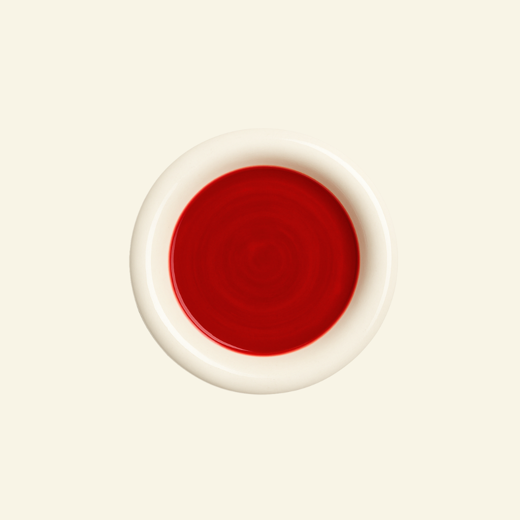 Two-Tone Chunky Ceramic Plate in red and white with a big rim on a beige background