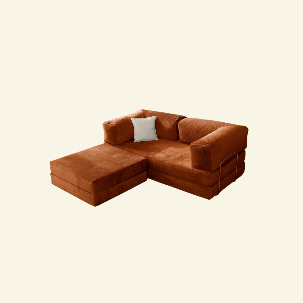 Brown sectional comfortform sofa including ottoman with a white pillow on a beige background