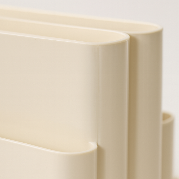 Close-up of beige cascade magazine rack on a light background
