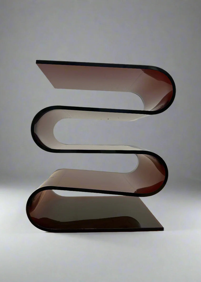 Modern, curved acrylic glass shelf on a plain background