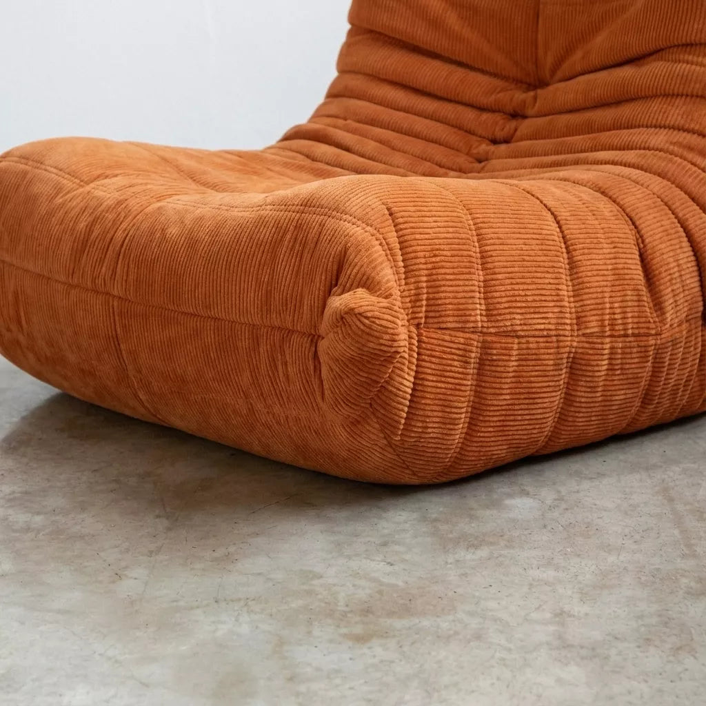 Close-up of the orange corduroy Bruma fireside chair lounger – soft, dirt-resistant fabric with comfortable texture