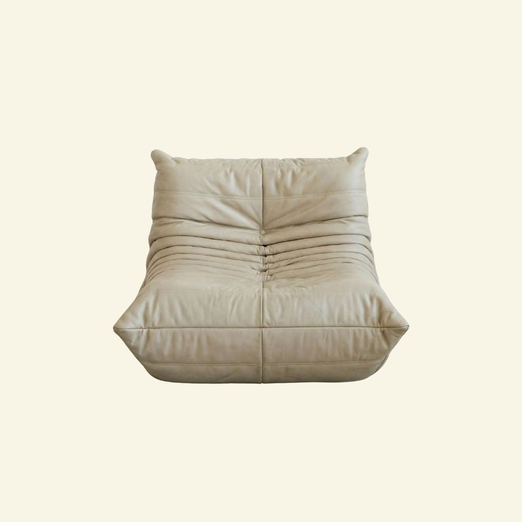 Bruma Chair in cream real cowhide leather on a beige background by vibehaus