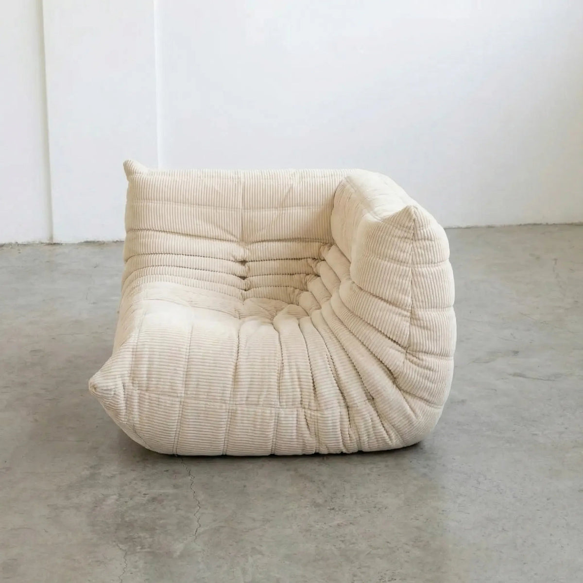 Bruma Sofa Corner in cream corduroy photographed from the front angle.
