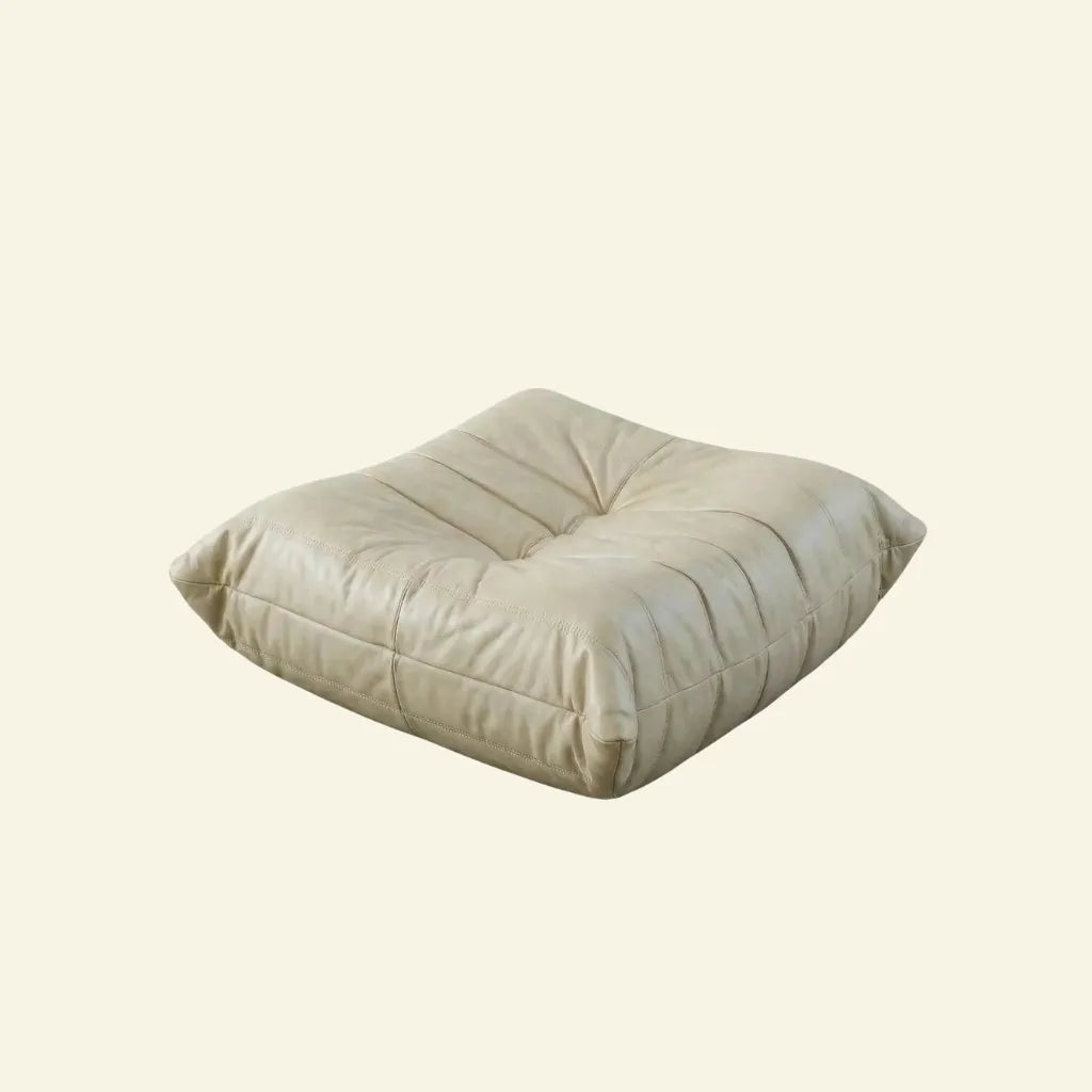 Beige Bruma leather ottoman on a beige background