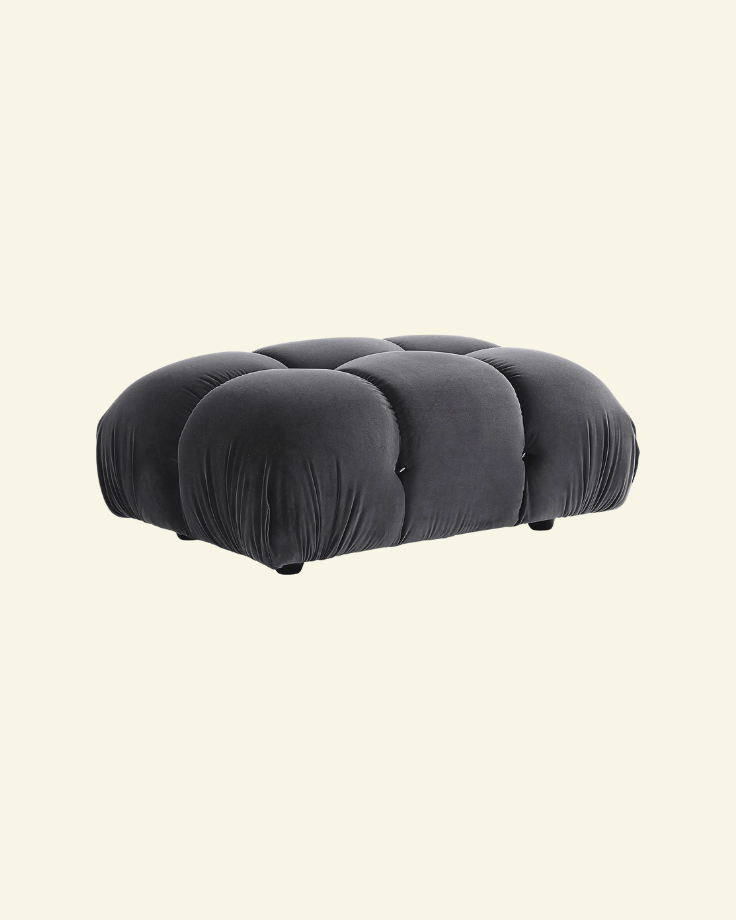 Camaleonda ottoman in black velvet replica with button-tufted detailing, shown in a high-resolution studio setting on a beige background.
