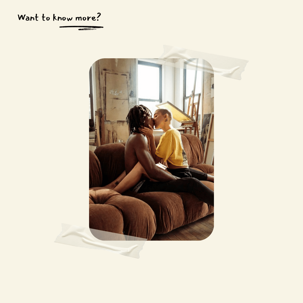 Two people kissing on a camaleonda replica couch in a room with a window.