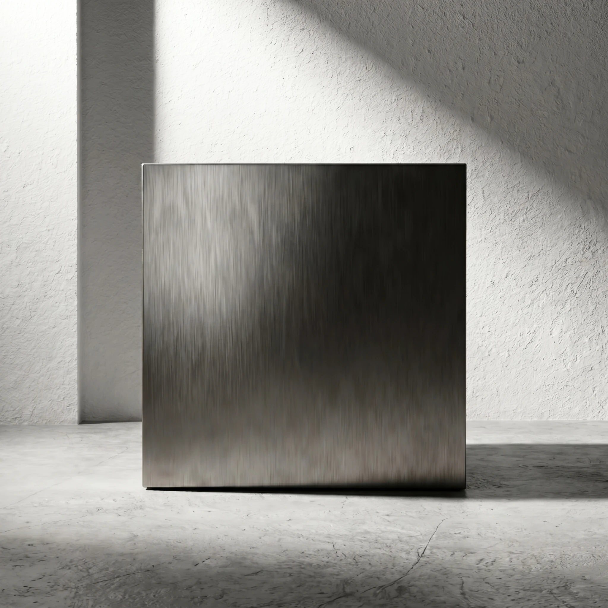 Straight-on crop of the Chrome Steel Cube Table highlighting its solid cube silhouette and brushed metal face.
