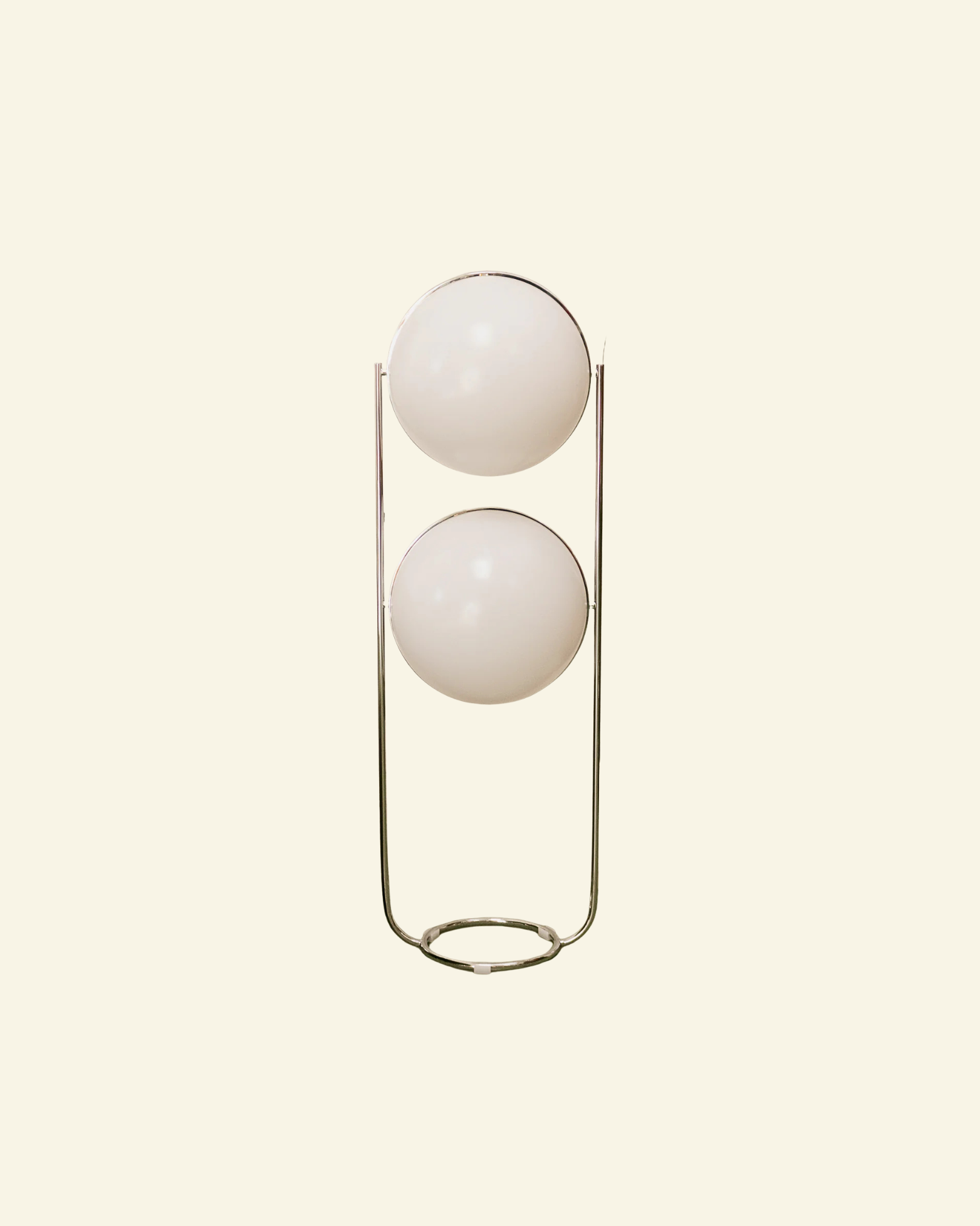 Modern floor lamp with two spherical globe white lights on a beige background