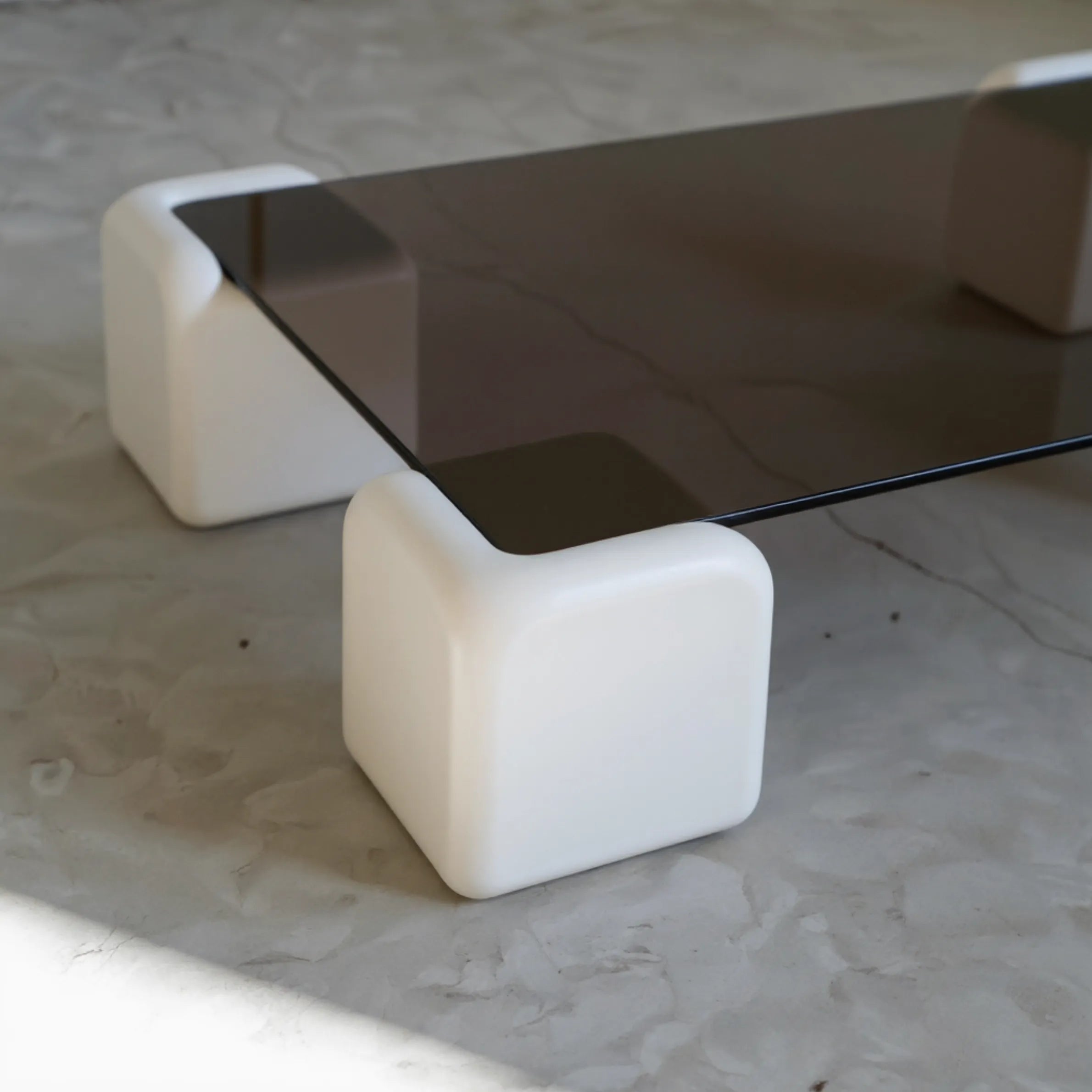 Elio Low Glass Coffee Table, a square glass coffee table with a low profile for modern lounge spaces, angled view