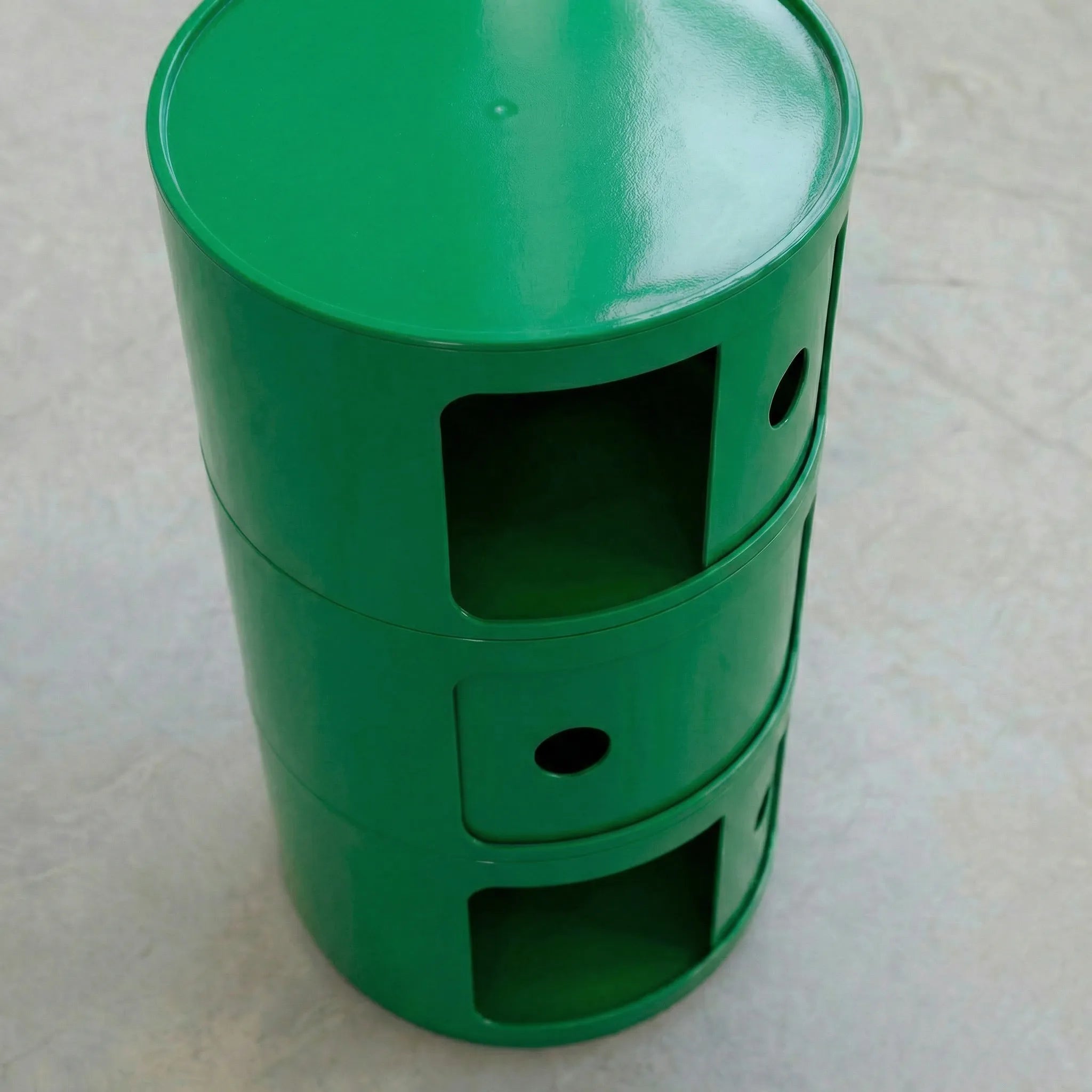 Green kartell componibili dupe storage unit with three drawers on a light gray surface.