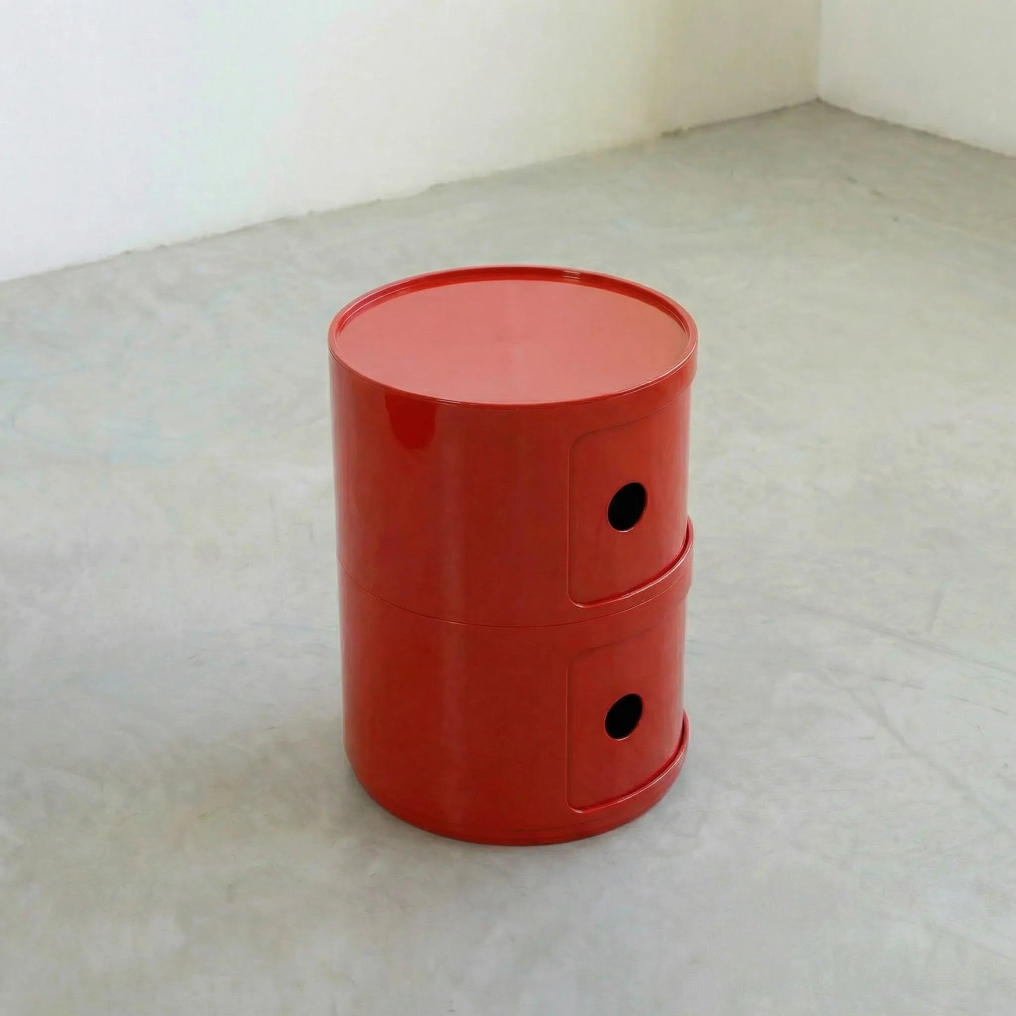 Red glossy round modular storage unit, Kartell Componibili dupe with two tiers in minimalist concrete studio