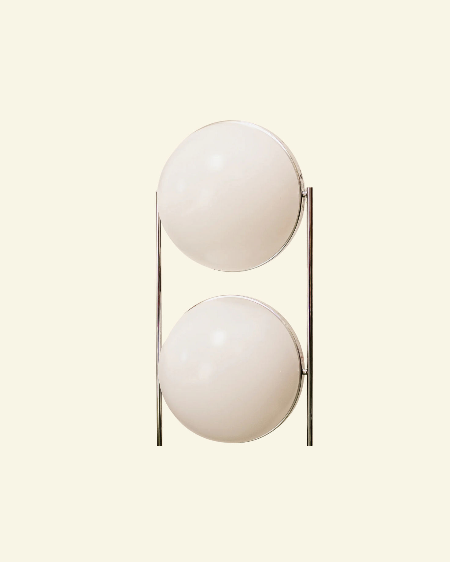Modern lamp with two globe spherical glass shades on a beige background
