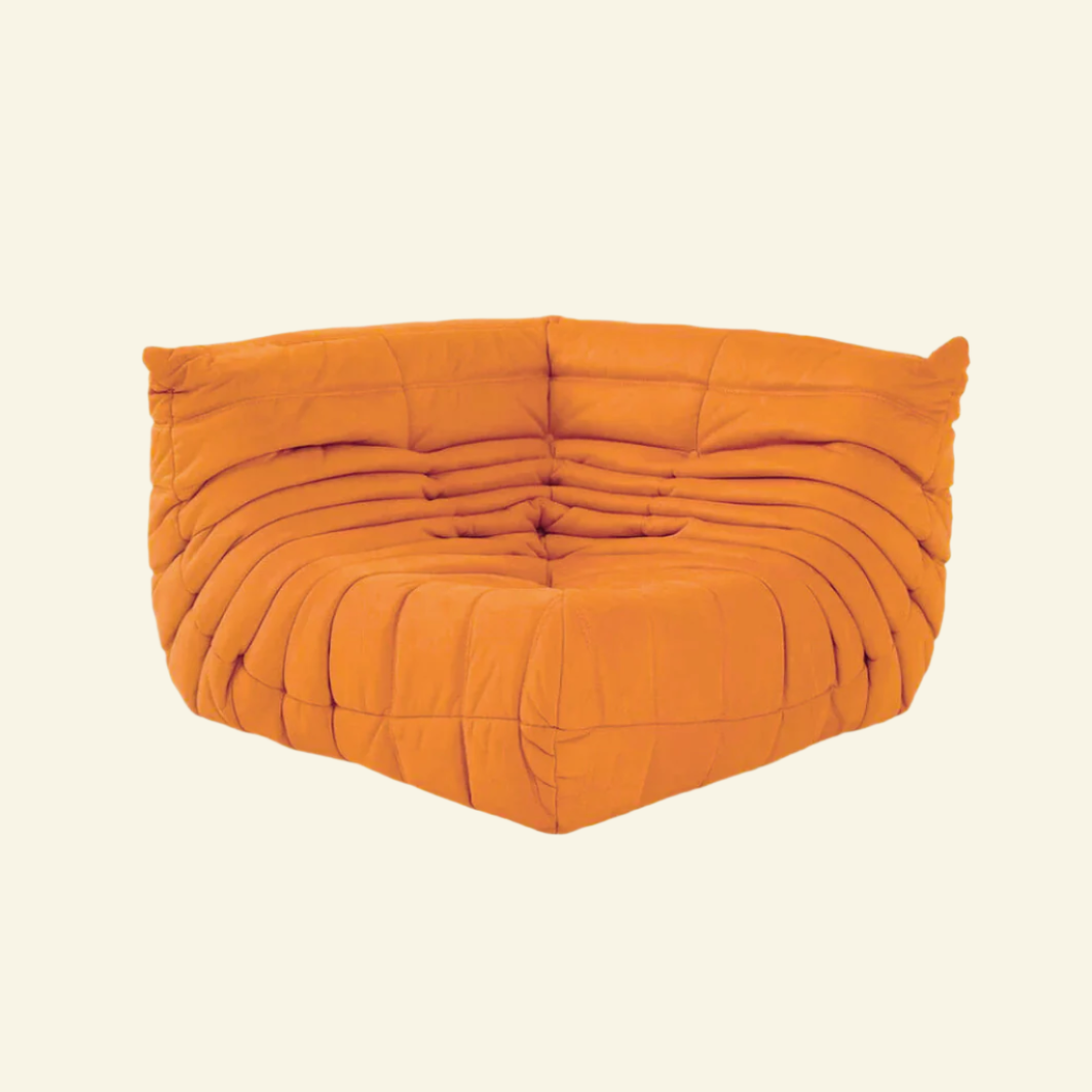 Ultra-comfortable orange Togo-inspired corner sofa chair with soft suede-like velvet – bold yet soothing furniture for creative homes
