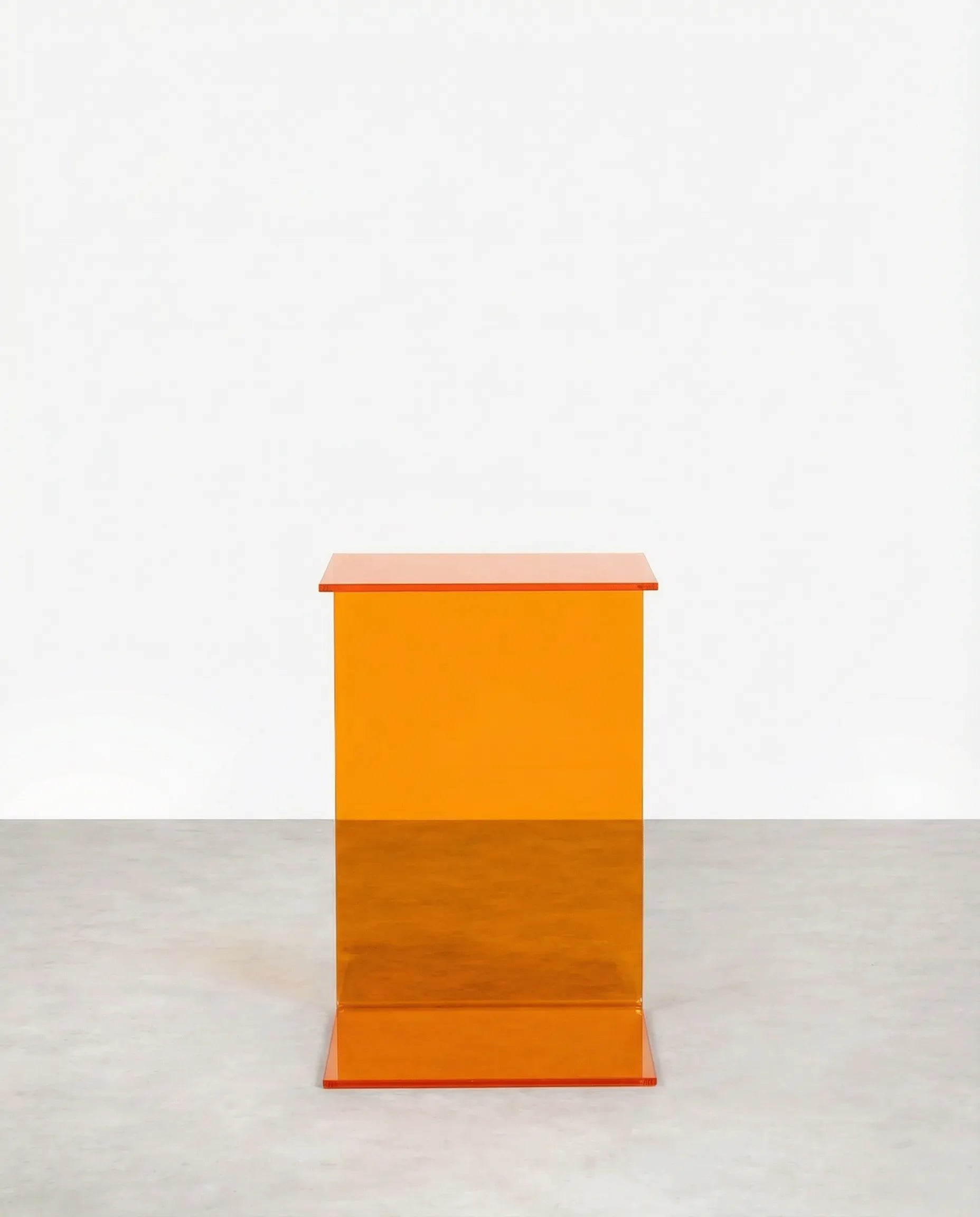 Orange c-shaped acrylic side table on a white background by vibehaus